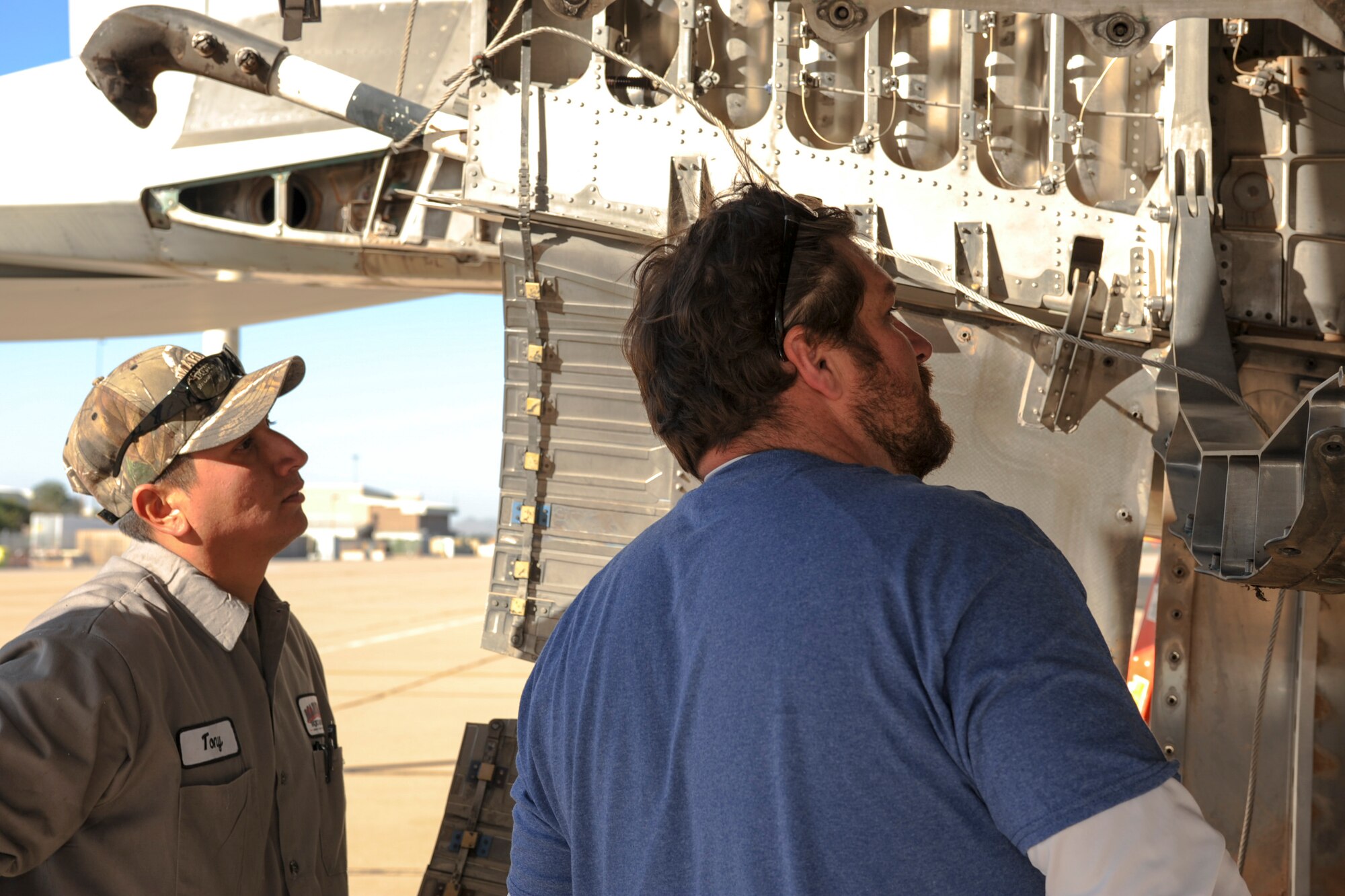 David Williamson, chief project manager, and Tony Martinez, crane mechanic, examine an F-15A Eagle for disassembly on the flightline at Davis-Monthan Air Force Base, Ariz., Nov. 17, 2015. Williamson will travel to Joint Base Lewis-McChord, Wash., to complete the project of reassembling the F-15A Eagle and putting it on display. The entire project is estimated to take approximately eight months from the planning stage to finish. (U.S. Air Force photo by Airman Basic Nathan H. Barbour/Released)