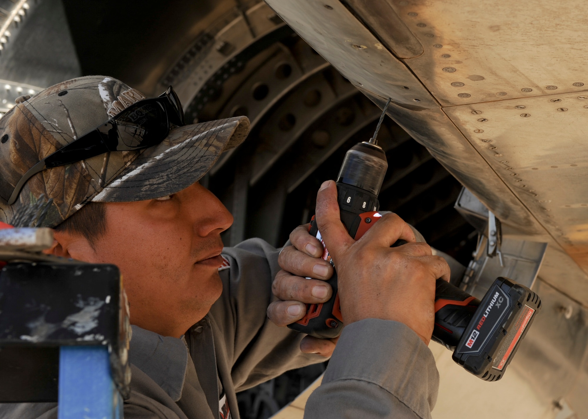 Tony Martinez, crane mechanic, removes a panel from an F-15A Eagle on the flightline at Davis-Monthan Air Force Base, Ariz., Nov. 17, 2015. A team of contractors took five days to completely disassemble the F-15A Eagle and load it onto two flatbed trucks to be shipped to Joint Base Lewis-McChord, Wash., for display. The entire project is estimated to take approximately eight months from the planning stage to finish. (U.S. Air Force photo by Airman Basic Nathan H. Barbour/Released)