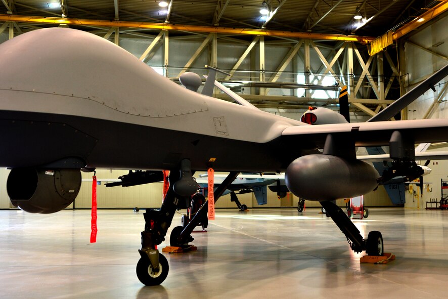 An MQ-9 Reaper Extended Range (ER) sits in a hangar Nov. 17, 2015, at Creech
Air Force Base, Nevada. The Reaper ER was operationally tested and fielded through the 556th Test and Evaluation squadron and Detachment 4, 53rd Test Management Group and can carry two external fuel tanks each holding 1,350 pounds of extra fuel allowing for a higher endurance time. Other upgrades included a four blade propeller and alcohol water injection. The aircraft also features new software updates allowing Air Combat Command
and Air Force Special Operations Command to operate on the same software
baseline ensuring everyone is on the same page as far as operating the aircraft. (U.S. Air Force photo by Airman 1st Class Christian Clausen/Released)

