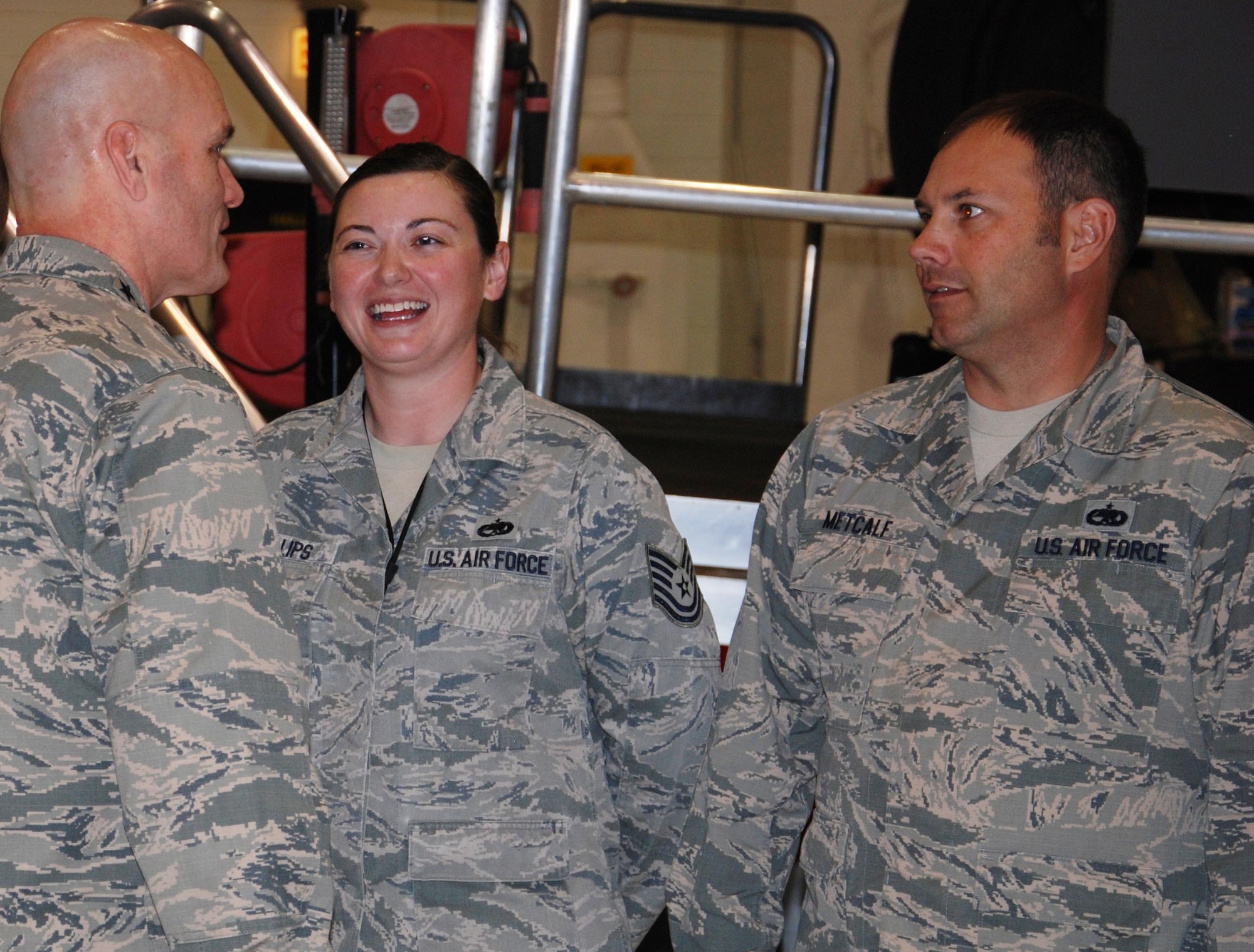 General Carlton Everhart, Air Mobility Command commander, greets Tech. Sgt. Anne Phillips, 931st Maintenance Squadron jet engine mechanic, and Tech. Sgt. Garrett Metcalf, 931 MXS periodic inspection crew chief, during a civic leader tour, Nov. 17, 2015, at McConnell Air Force Base, Kan. Everhart joined AMC civic leaders on a total force tour to display the base's current aerial refueling mission. (U.S. Air Force photo by Tech. Sgt. Abigail Klein)