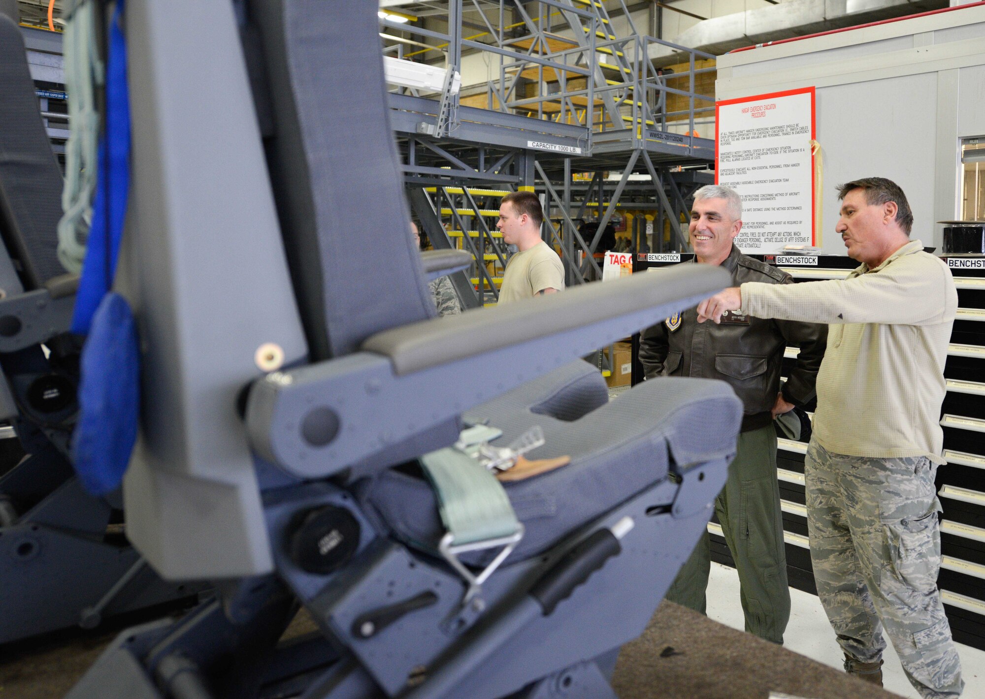 Tech. Sgt. Mark Verdugo, 934th Maintenance Squadron, explains the seat overhaul procedure to Col. Keith Wesley, 934th Airlift Wing commander. The seats were completely disassembled and rebuilt in-house by 934th maintainers saving thousands of dollars over purchasing new seats. (Air Force Photo/Paul Zadach)