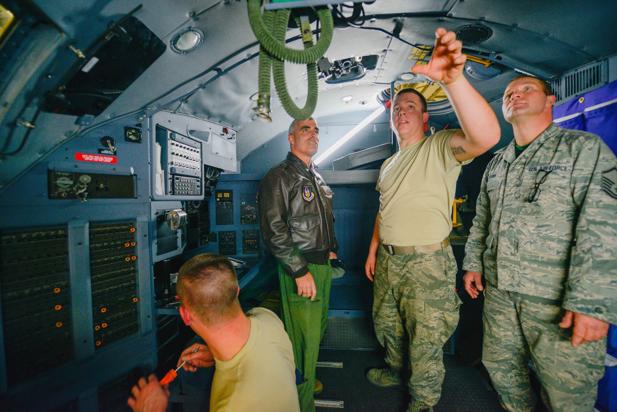 Staff Sgt. Jacob Haefemeyer (center), 934th Maintenance Squadron, shows Col. Keith Wesley, 934th Airlift Wing commander, (left) the newly refurbished flight deck of one of the 934th Airlift Wing's C-130s, as Master Sgt. Jude Quinn, who managed the project, looks on. The aircraft is the fourth that received refurbished interior including a new diamondplate floor, ceiling and wall materials, paint and refurbished seats. (Air Force photo/Paul Zadach)