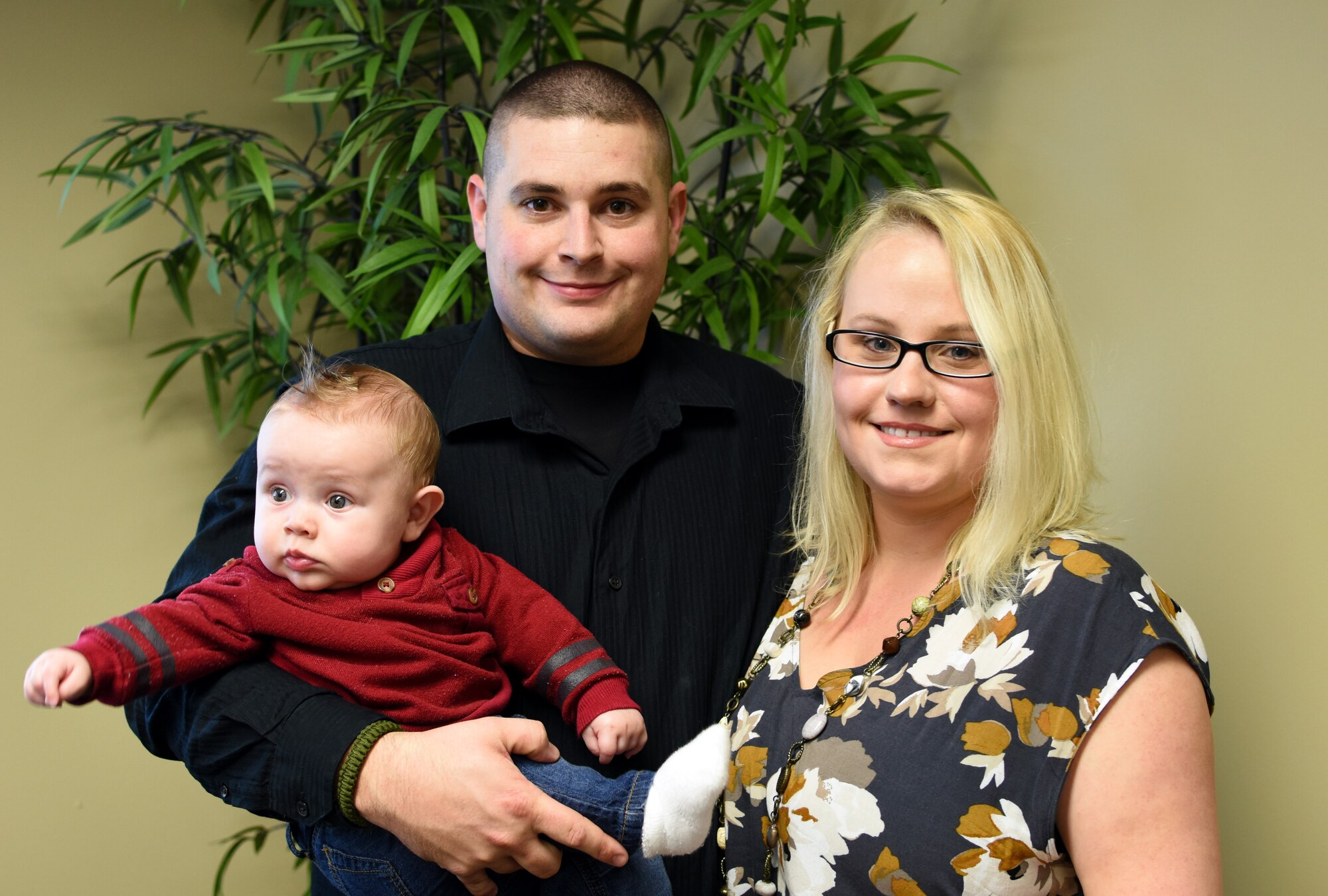 Senior Airman Charles Thornburg stands with his family after receiving a presentation on the wing’s new mission sets and provided tips for their physical and mental health at Ebbing Air National Guard Base, Fort Smith Ark., Nov. 7, 2015. Thornburg transferred to the 188th Wing last month and brought his family to learn about the wing’s new mission sets. (U.S. Air National Guard photo by Senior Airman Cody Martin/Released)