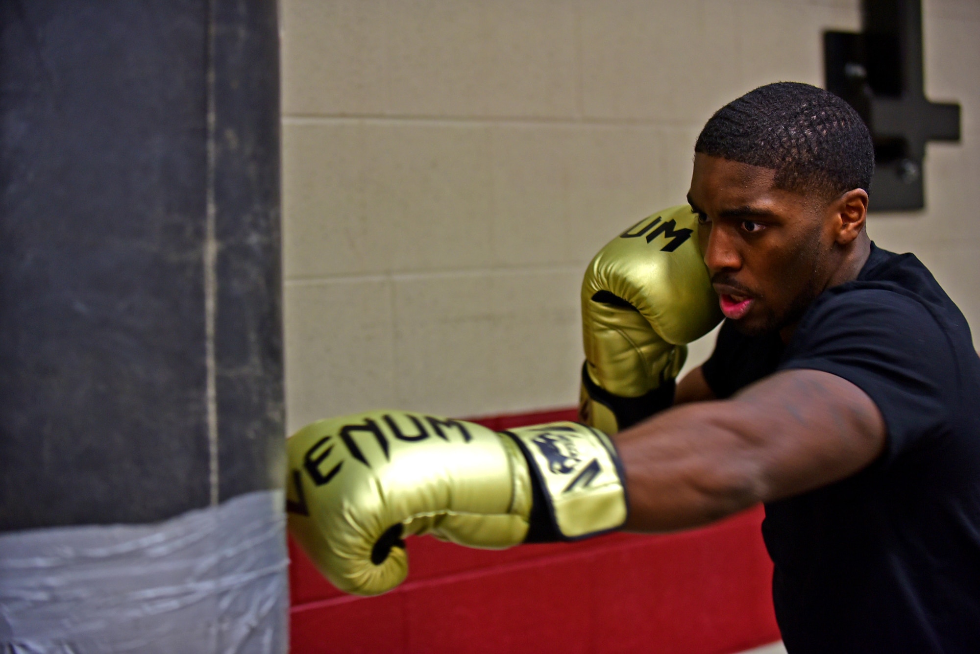 Senior Airman Colton Taylor, 28th Force Support Squadron services journeyman, strikes a punching bag during a boxing training session at the Bellamy Fitness Center at Ellsworth Air Force Base, S.D., Nov. 10, 2015. Taylor trains daily, with workouts lasting anywhere from 45 minutes to three hours. (U.S. Air Force photo by Airman 1st Class James L. Miller/Released)  