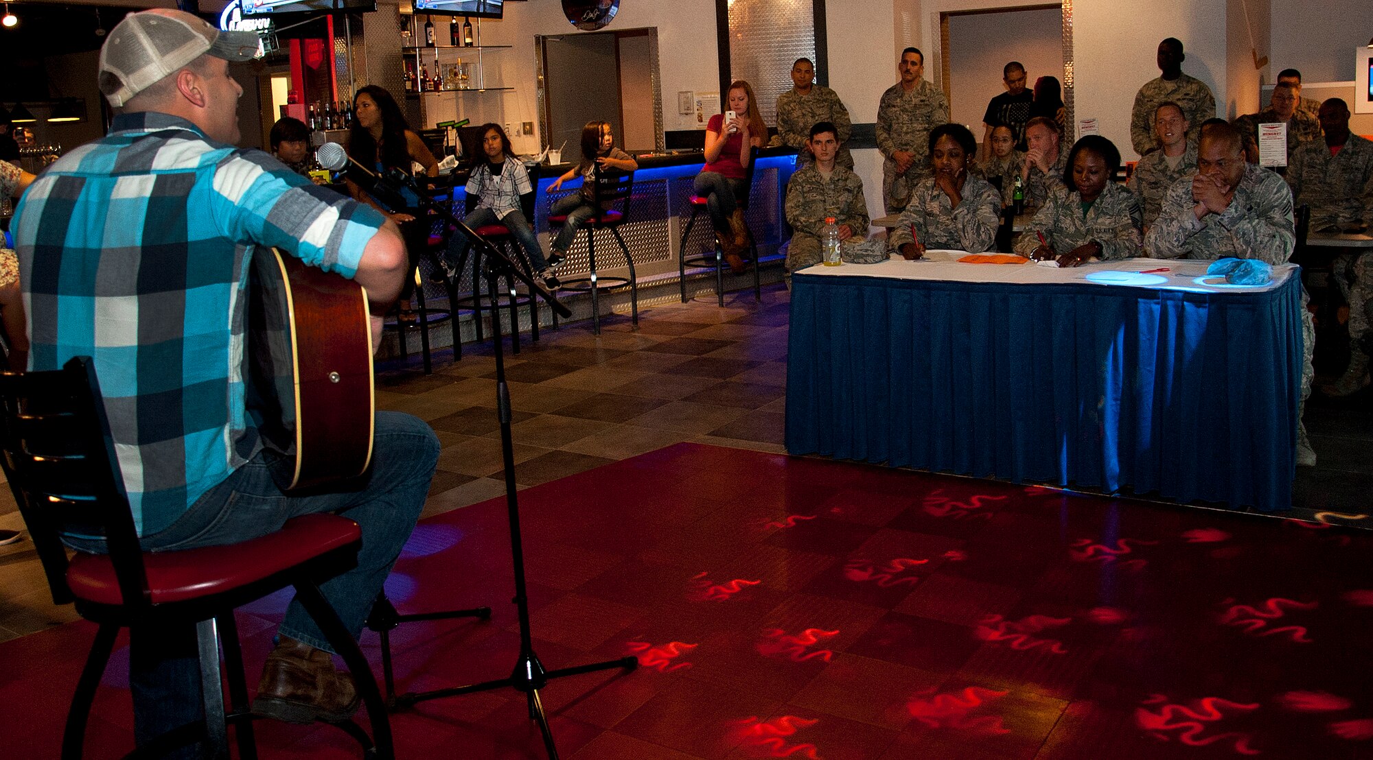 Airman 1st Class Timothy Goss, a medical laboratory technician assigned to the 6th Medical Support Squadron performs during the first ever Junior Enlisted Council Talent Show Nov. 13, 2015, at MacDill Air Force Base, Fla. Goss showcased guitar and vocal talents by performing Old Crow Medicine Show’s version of “Wagon Wheel” and was the first place winner. (U.S. Air Force photo by Senior Airman Jenay Randolph)