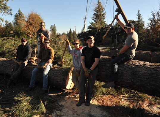 Members of the 336th Training Group, rest while helping clean-up downed trees from a severe windstorm, Nov. 20, 2015 in Spokane, Wash. Approximately 100,000 people experienced power outages and several had to their homes or yard. The volunteers wanted to help the community out by removing parts of trees from yards. (U.S. Air Force photo/Staff Sgt. Jason Bailey) 
