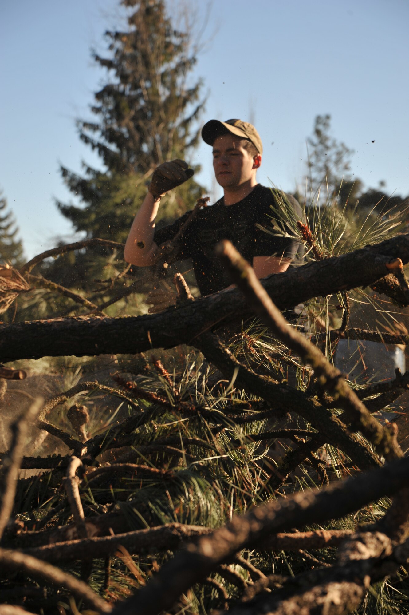 Senior Airman Matthew Montour, 22nd Training Squadron Survival Evasion Resistance and Escape specialist, breaks down branches during a volunteer community cleanup event, Nov. 20, 2015 in Spokane, Wash. Members from the 22nd TRS helped clear downed trees after a severe windstorm that caused damage to the area. (U.S. Air Force photo/Staff Sgt. Jason Bailey)