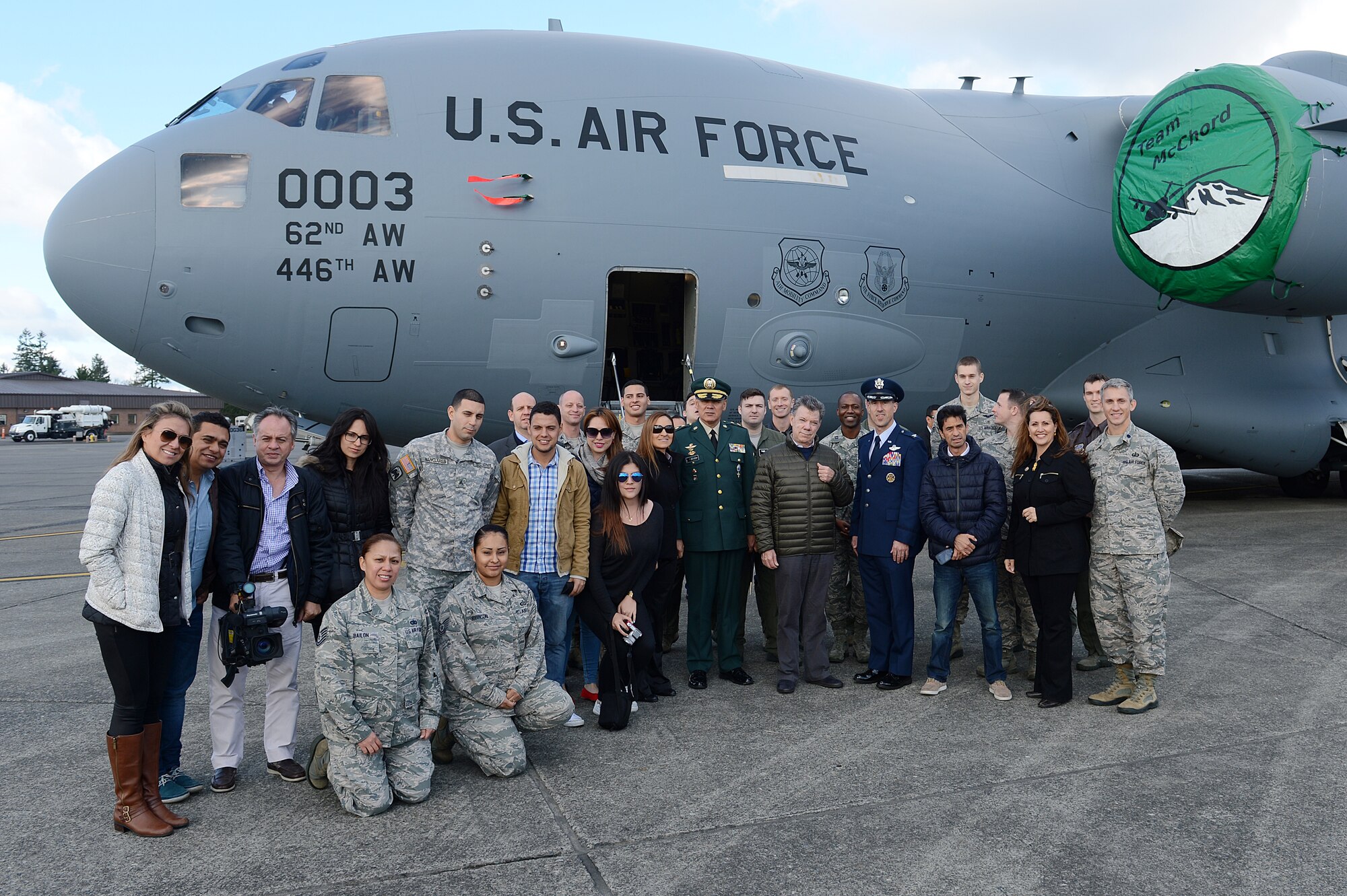 Juan Santos, President of Colombia, and his entourage, pose for a photo with members of Team McChord Nov. 19, 2015 at Joint Base Lewis-McChord, Wash. Members of Team McChord volunteered to be interpreters  while Santos and his entourage toured a C-17 Globemaster III.  (U.S. Air Force photo/Senior Airman Divine Cox)