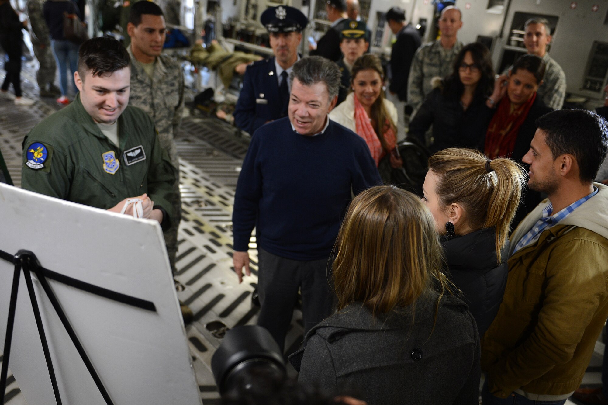 Senior Airman Auston Corbett (left), 8th Airlift Squadron loadmaster, briefs Juan Santos (center), President of Colombia, inside a C-17 Globemaster III on the McChord Field flight line, Nov. 19, 2015, at Joint Base Lewis-McChord, Wash. Santos received mission briefs on aeromedical evacuation, combat air drop, and Operation Deep Freeze.  (U.S. Air Force photo/Senior Airman Divine Cox)
