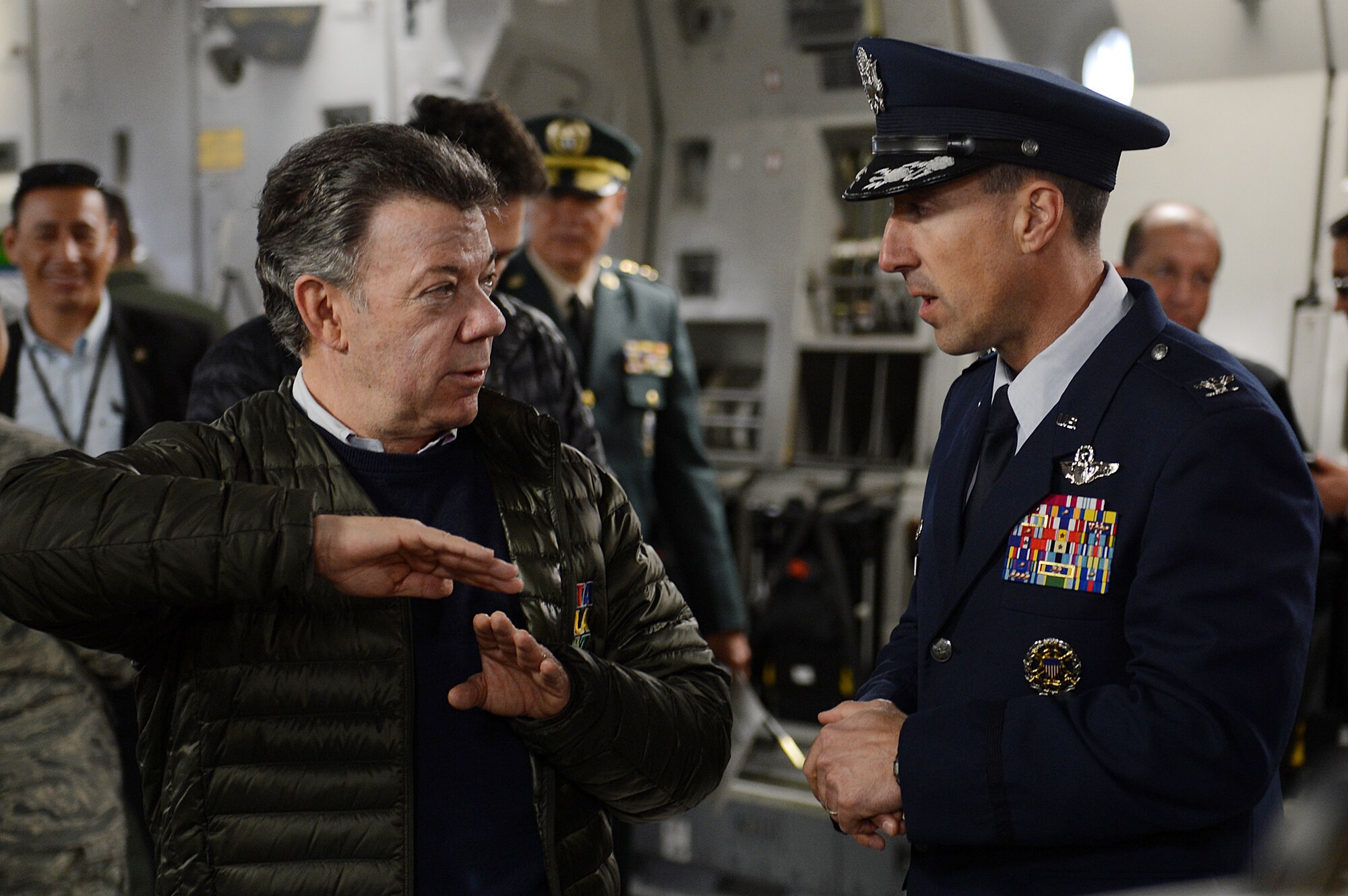 Juan Santos (left), President of Colombia and Col. Leonard Kosinski, 62nd Airlift Wing commander talk about the Team McChord C-17 Globemaster III mission Nov. 19, 2015, at Joint Base Lewis-McChord, Wash. Santos received a static tour of the C-17 while waiting on his aircraft to be refueled. (U.S. Air Force photo/Senior Airman Divine Cox)