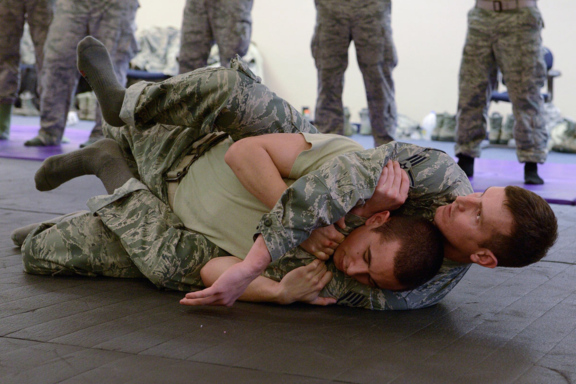Staff Sgt. Heath Parish holds Senior Airman Sean Pender in a rear-neck restraint during combatives training at Joint Base Elmendorf-Richardson, Alaska, Nov. 9, 2015. The combatives training teaches Airmen to use their skill sets to escape compromising situations and regain control. Parish and Pender are both assigned to the 673d Security Forces Squadron. (U.S. Air Force photo by Airman Valerie Monroy)