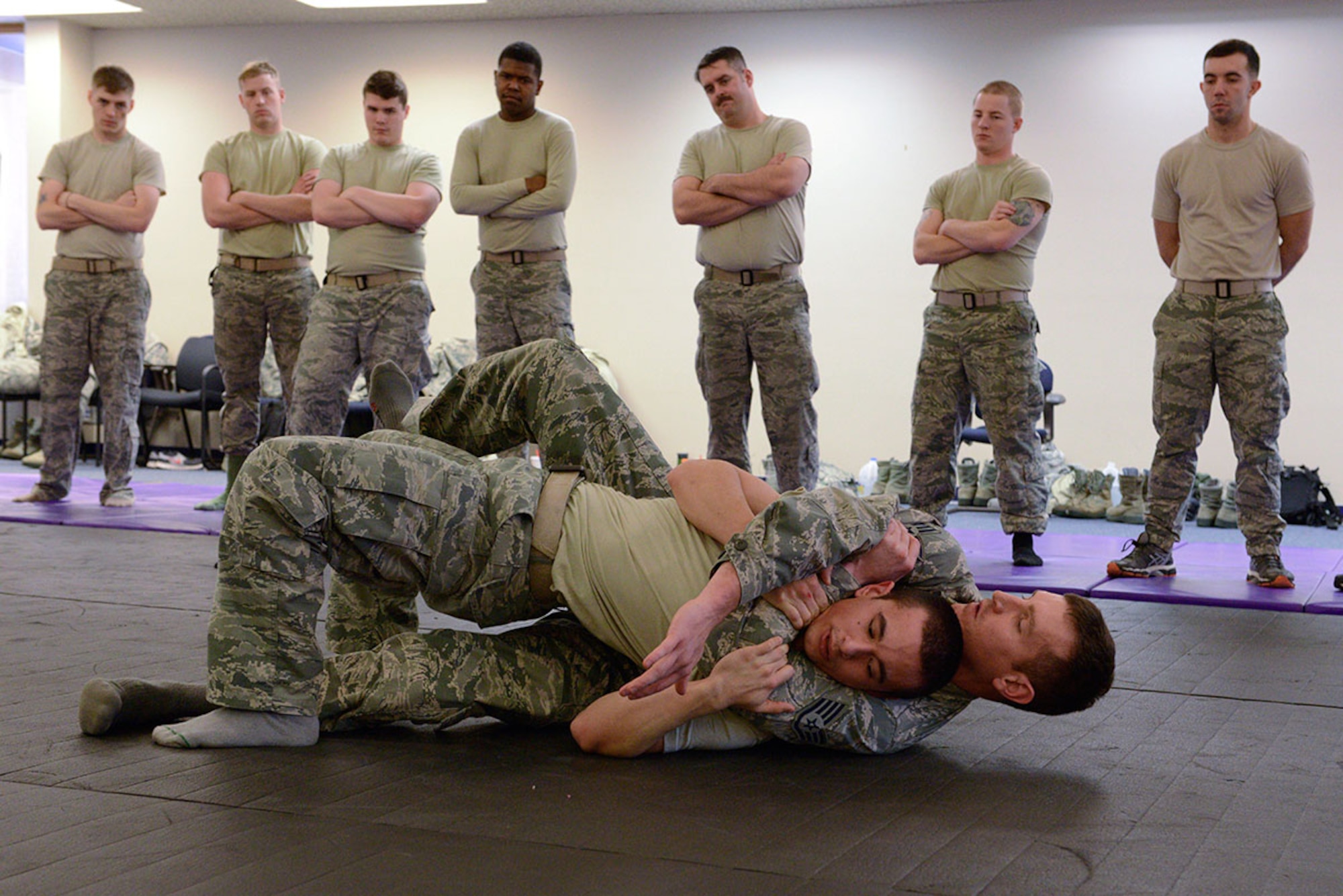 Staff Sgt. Heath Parish holds Senior Airman Sean Pender in a rear-neck restraint during combatives training. Parish and Pender are both assigned to the 673d Security Forces Squadron. (U.S. Air Force photo/Airman Valerie Monroy)