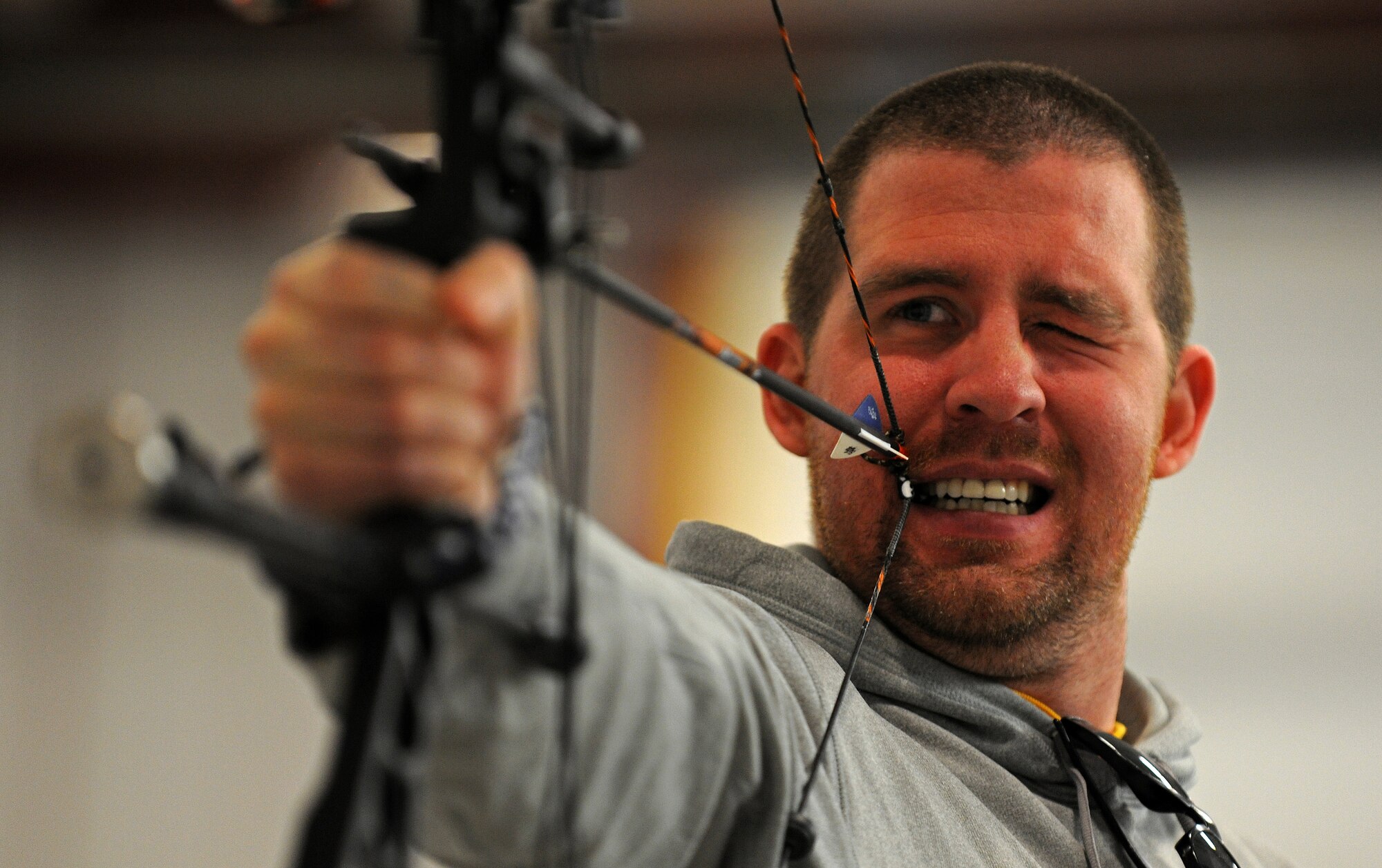 Retired Staff Sgt. Garrett Pope uses a bite tab to pull back the string of a bow as he prepares to fire during the  Northeast Region Warrior CARE Event at Joint Base Andrews, Md., Nov. 17. The event is in conjunction with Warrior Care Month, a month dedicated to honoring the courage, resilience and accomplishments of wounded, ill and injured service members, their families and their caregivers. (U.S. Air Force Photo/Tech. Sgt. Brian Ferguson)