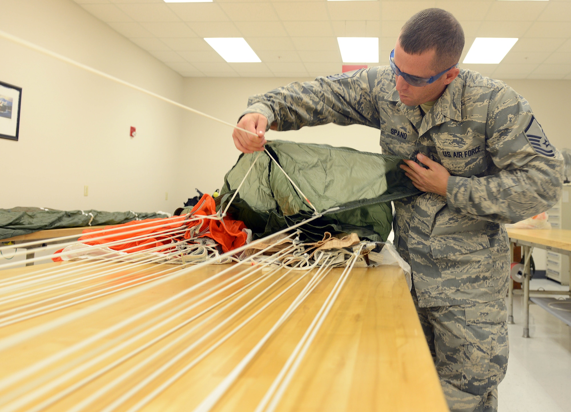 Master Sgt. Kevin Spano, 339th Flight Test Squadron aircrew flight equipment, inspects an Advanced Concept Ejection Seat canopy. Activation of an aircraft ejection seat by a crewmember sets off a chain of events that propels the canopy away from the plane and thrusts the crewmember safely away from the aircraft. (U.S. Air Force photo by Tommie Horton)