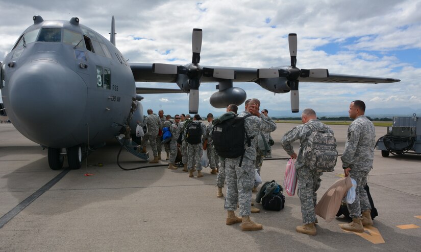Joint Security Forces members from Soto Cano Air Base, Honduras, board a C-130H Hercules during their redeployment to Puerto Rico, Nov. 19, 2015, after completing a deployment in Honduras. The JSF members were stationed in Honduras for nine months before swapping out with a new unit. (U.S. Air Force photo by Martin Chahin/Released)