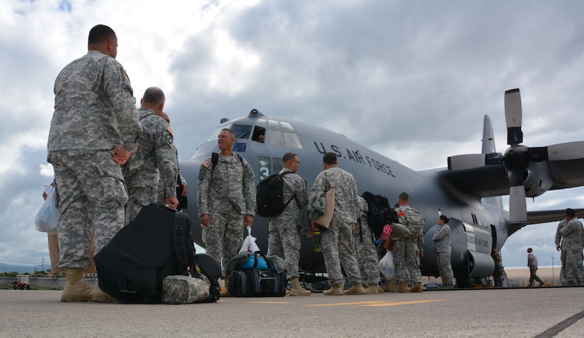 Joint Security Forces members say farewell to friends at Soto Cano Air Base, Honduras, as they board a C-130H Hercules to redeploy to Puerto Rico, Nov. 19, 2015. The JSF members, from Puerto Rico, were stationed in Honduras for nine months before swapping out with a new unit. (U.S. Air Force photo by Martin Chahin/Released)