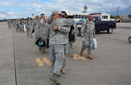 Joint Security Forces members say farewell to friends at Soto Cano Air Base, Honduras, as they board a C-130H Hercules to redeploy to Puerto Rico, Nov. 19, 2015. The JSF members, from Puerto Rico, were stationed in Honduras for nine months before swapping out with a new unit. (U.S. Air Force photo by Martin Chahin/Released)