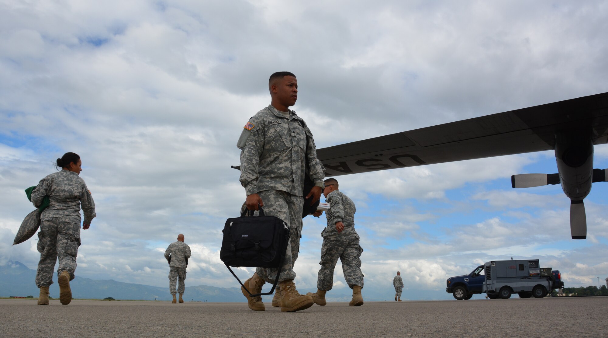 U.S. Army Spc. Gadiel Araujo, Joint Security Forces member, Soto Cano Air Base, Honduras, boards a C-130H Hercules during his redeployment to Puerto Rico, Nov. 19, 2015, after completing a deployment in Honduras. The JSF members were stationed in Honduras for nine months before swapping out with a new unit. (U.S. Air Force photo by Martin Chahin/Released)