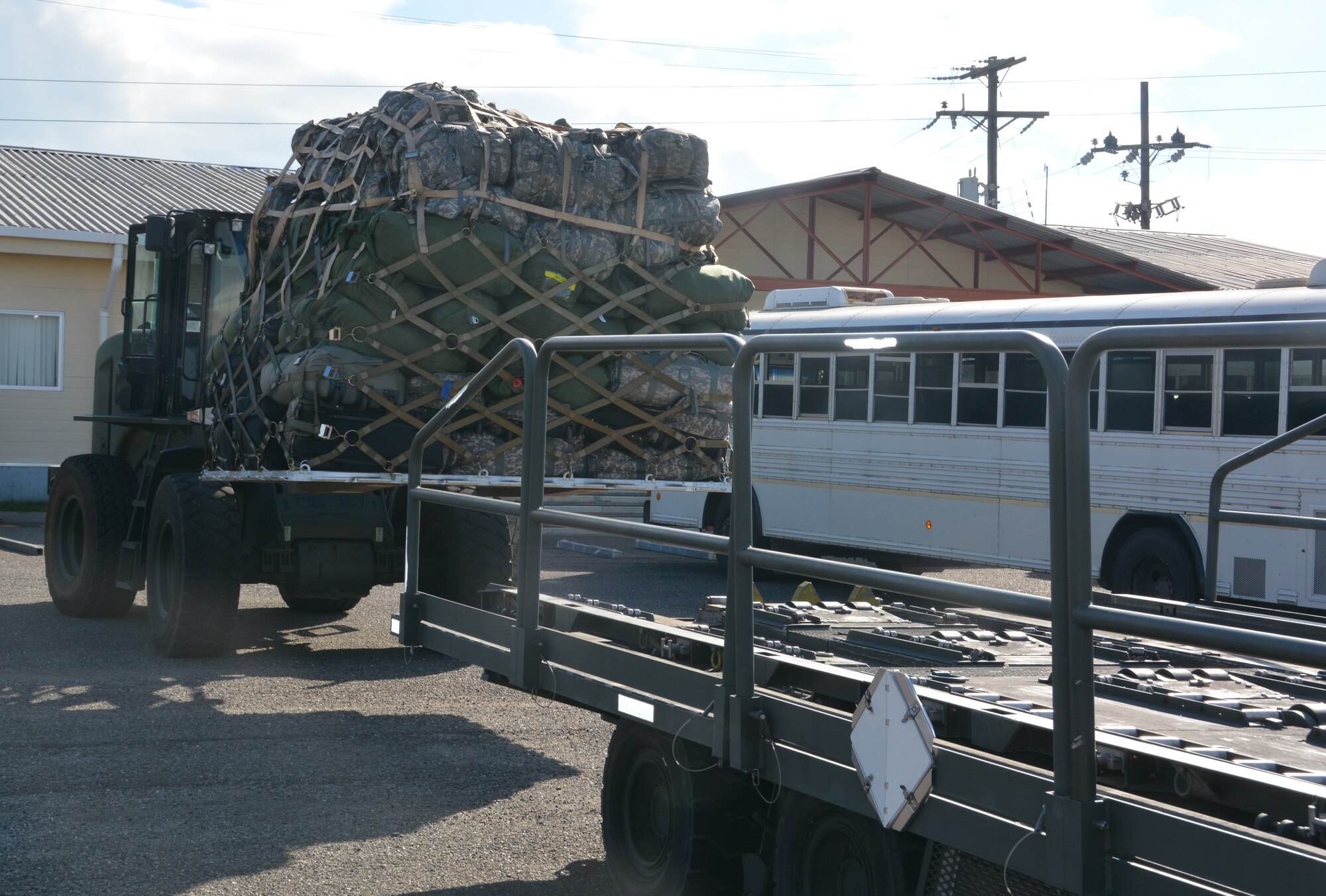 A 612th Air Base Squadron member loads Joint Security Forces members' cargo as they redeploy from Soto Cano Air Base, Honduras, Nov. 19, 2015, after completing their deployment in Honduras. The JSF members returned to Puerto Rico after they were stationed in Honduras for nine months. (U.S. Air Force photo by Martin Chahin/Released)