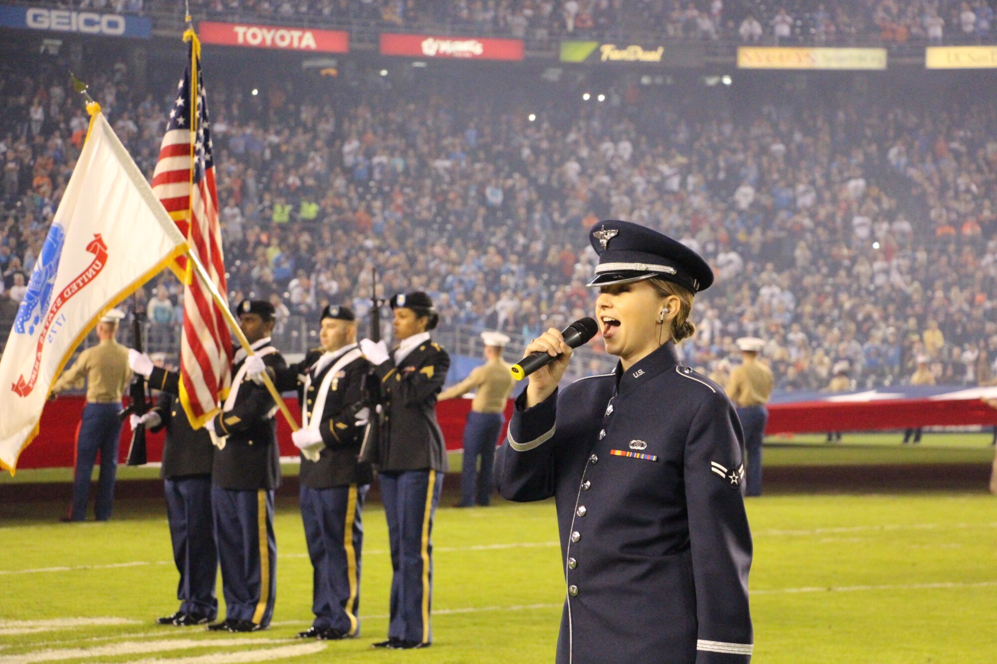 Airman 1st Class Michelle Doolittle, right, U.S. Air Force Band of the Golden West vocalist, sings The Star-Spangled Banner Nov. 9 at Qualcomm Stadium in San Diego, Calif. The performance was part of the San Diego Chargers' Salute to Service prior to their Monday Night Football game against the Chicago Bears. 