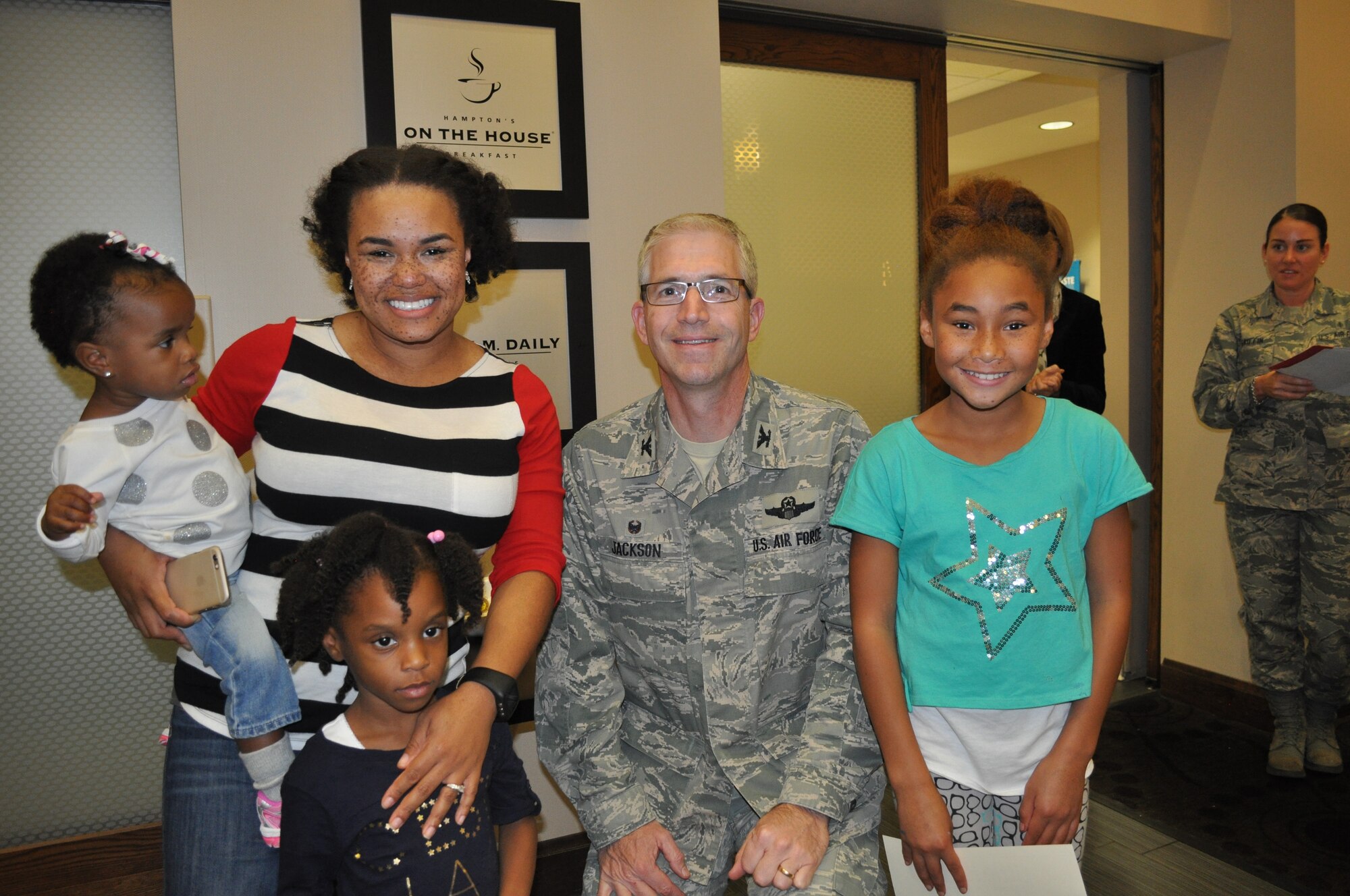 The family of a Travis Air Force Base, Calif., deployed Airman pose for a photo with Col. Joel Jackson, 60th Air Mobility Wing commander, after receiving their certificates and coins. (U.S. Air Force photo by Ellen Hatfield)