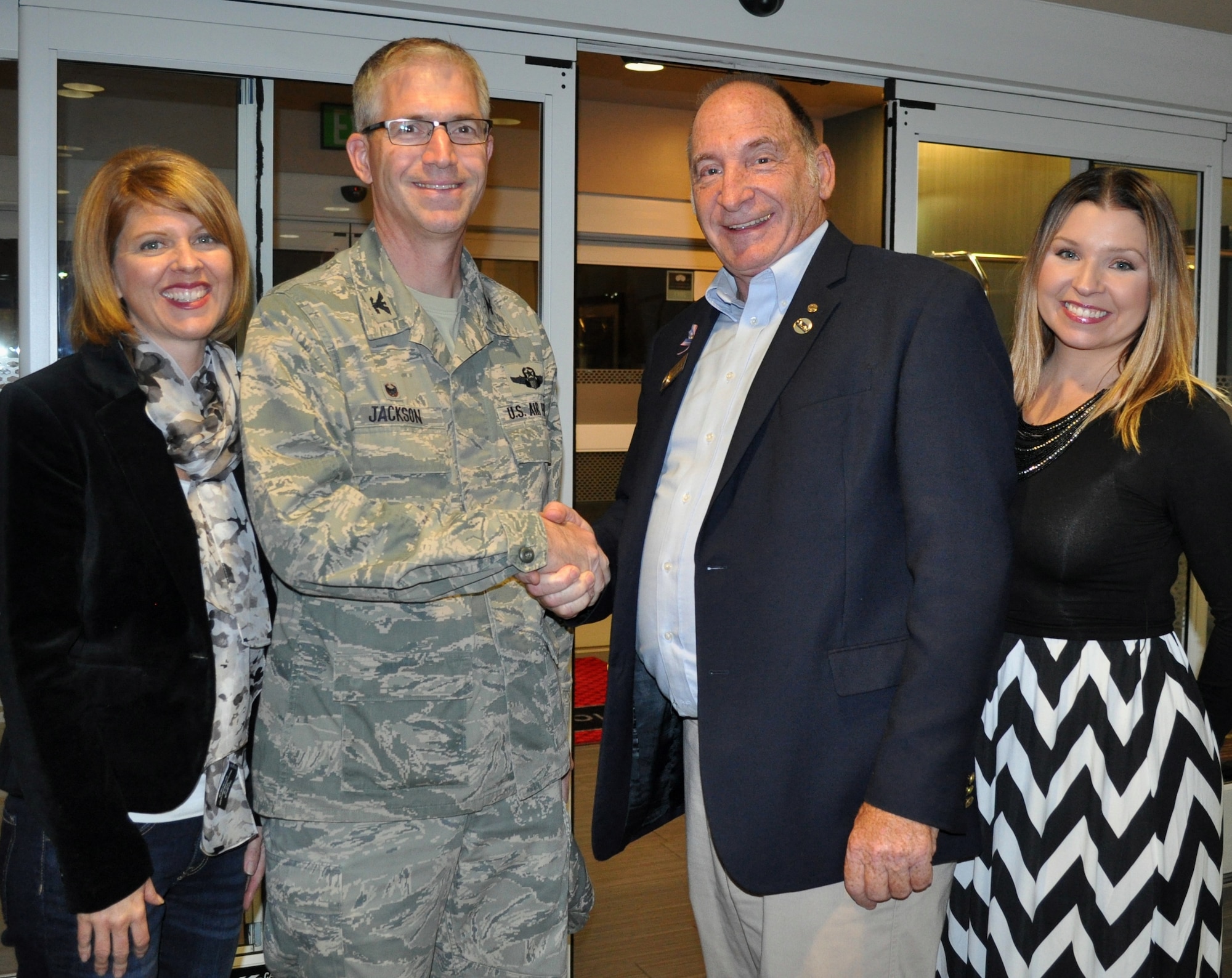Mike Segala, second from right, Travis Regional Armed Forces Committee treasurer, and Shelley Merritt, right, Travis Airman and Family Readiness Center work and life specialist, greet  Col. Joel Jackson, second from left, 60th Air Mobility Wing commander, and his wife Lanette, as they arrive Nov. 18 at the Hampton Inn in Suisun City for the Little Heroes program. (U.S. Air Force photo by Ellen Hatfield)