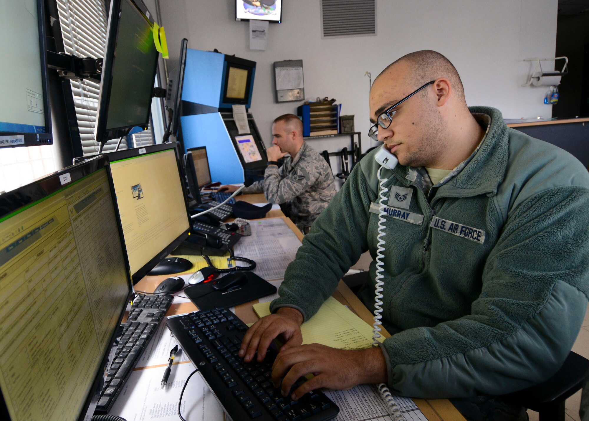 U.S. Air Force Staff Sgt. Chris Murray, 31st Security Forces Squadron desk sergeant, updates an event log, Nov. 18, 2015, at Aviano Air Base, Italy. Law enforcement desk personnel act as the dispatchers for patrol units. (U.S. Air Force photo by Senior Airman Austin Harvill/Released)