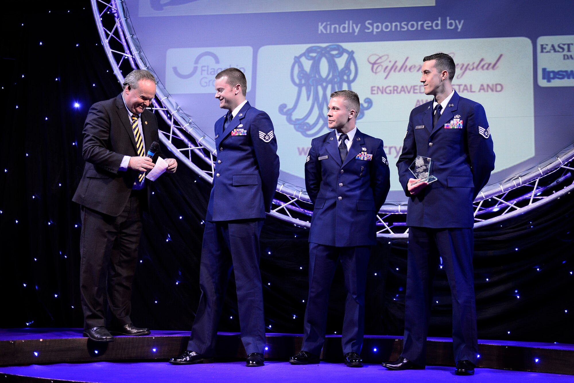 Staff Sgt. Matthew Jeffers, Senior Airman Nevin Wolsleben and Staff Sgt. Greggory Swarz, 48th Aircraft Maintenance Squadron, receive the Armed Services of the Year award at the Stars of Suffolk awards ceremony in Ipswich, England, Nov. 19, 2015. Out of 300 nominations in 14 categories, Airmen from Royal Air Force Lakenheath, England, were recognized for their heroic actions. (U.S. Air Force photo by Airman 1st Class Erin R. Babis/Released)