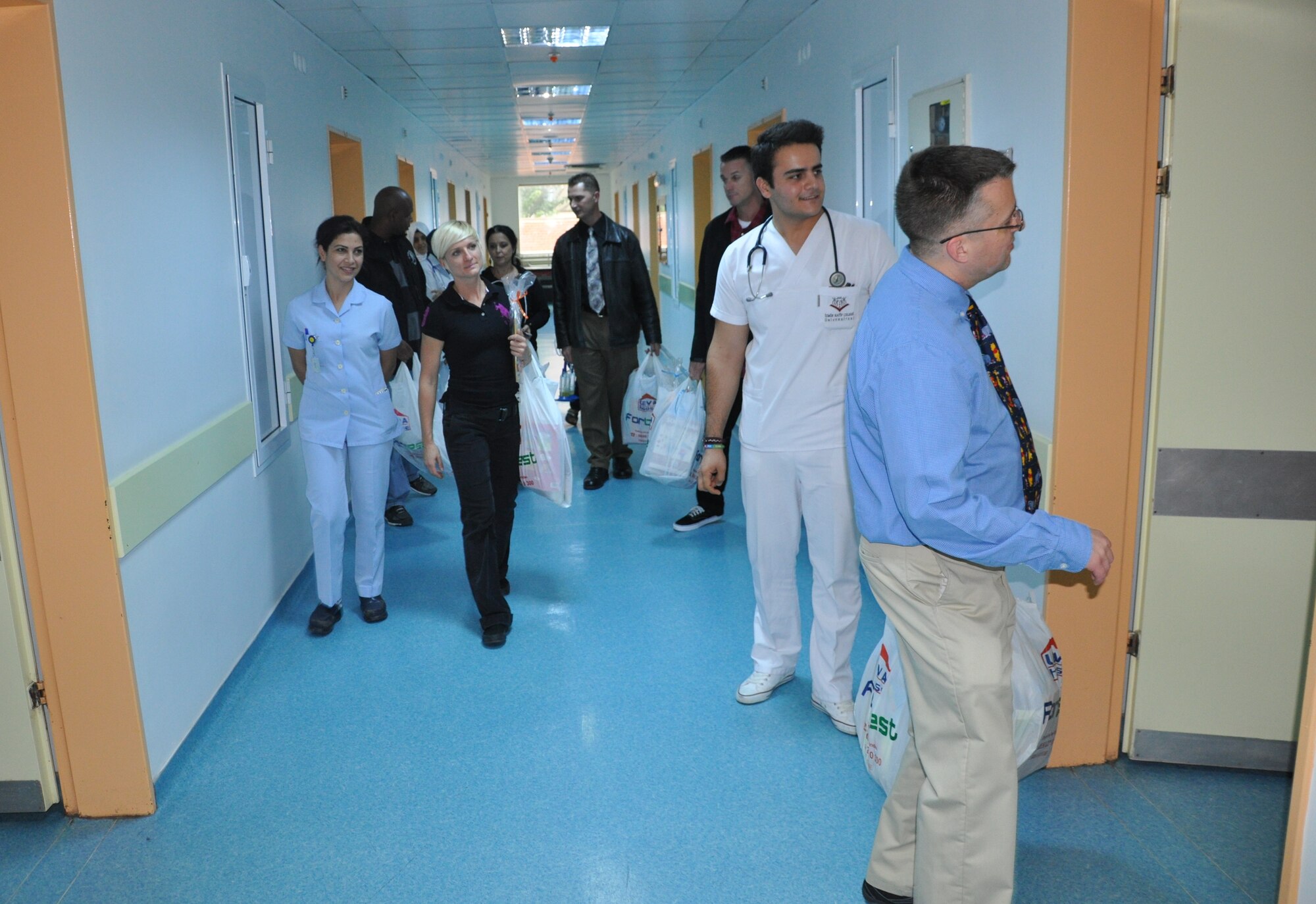 425th Air Base Squadron members, as well as volunteers, hand out children’s 
classics books, coloring books, pencils, crayons and puzzles to more than 150 
children at a local children’s hospital during a community outreach event Nov. 6, 2015. (U.S. Air Force photo by Tanju Varlikli/Released)
