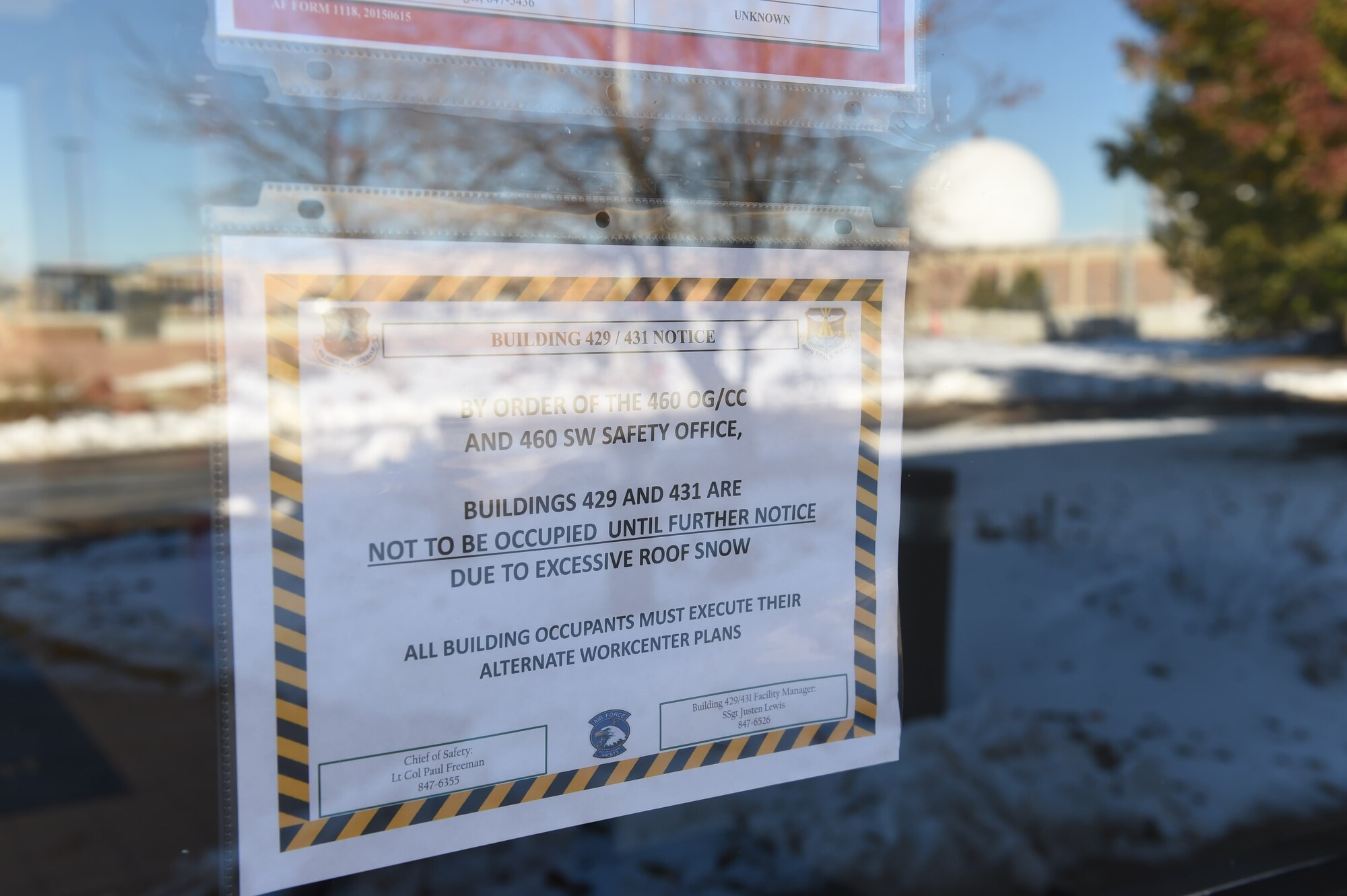 A sign is placed on the inside of Bldg. 429 when snow accumulation reaches over six inches, Nov. 18, 2015, on Buckley Air Force Base, Colo. Currently, occupants of Bldg. 431 and 429 must evacuate the buildings and find alternate duty locations when it snows. A proposal is in place to demolish these buildings and build the SBIRS Operations Facility, which is set to consolidate the work centers and offer permanent homes to the nearly 200 people who work in the existing facilities. (U.S. Air Force photo by Airman 1st Class Samantha Meadors/Released)