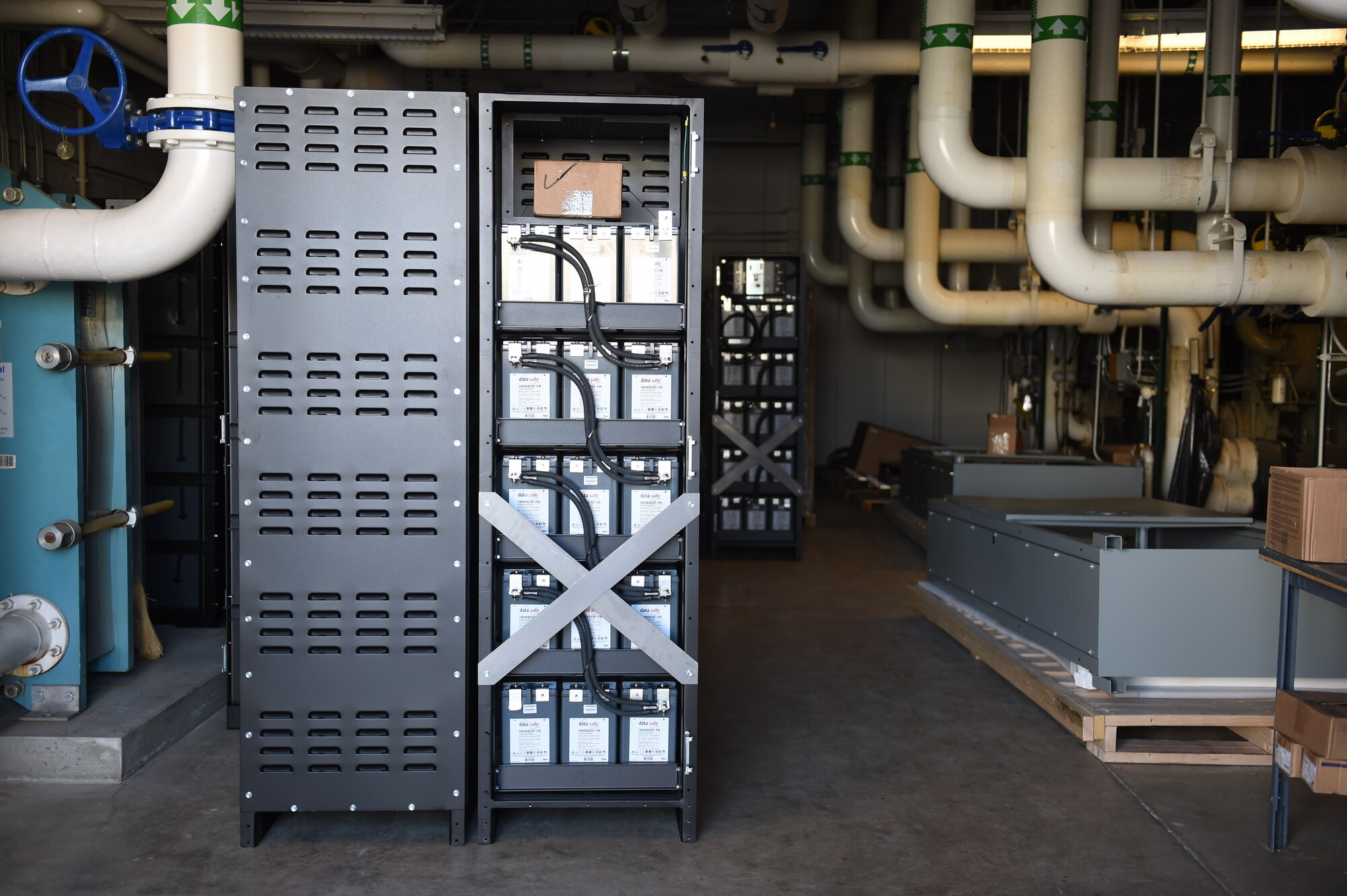 A storage unit behind the 460th Operations Group Mission Control Station houses new batteries that will eventually supply power to Space-based Infrared System assets, Nov. 18, 2015, on Buckley Air Force Base, Colo. The Mission Control Station currently relies on backup power owned and controlled by the Aerospace Data Facility Colorado next door. The new project will expand the electrical infrastructure in the restricted area for dependable commercial power and independent backup generators for the SBIRS MCS. (U.S. Air Force photo by Airman 1st Class Samantha Meadors/Released)