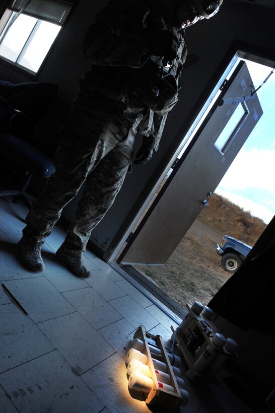 Staff Sgt. Daniel Rosemier, an Explosive Ordnance Craftsman with the 775th EOD Flight investigates a set of bombs discovered while his team is processing a homemade explosives lab in an abandoned trailer. After they secured the explosives, the team conducted a search of the trailer, carefully documenting everything for law enforcement use. The training scenario was part of a week-long training event Nov. 2.-6, meant to pass on knowledge from veteran EOD techs to their younger counterparts. (U.S. Air Force photo/Micah Garbarino)