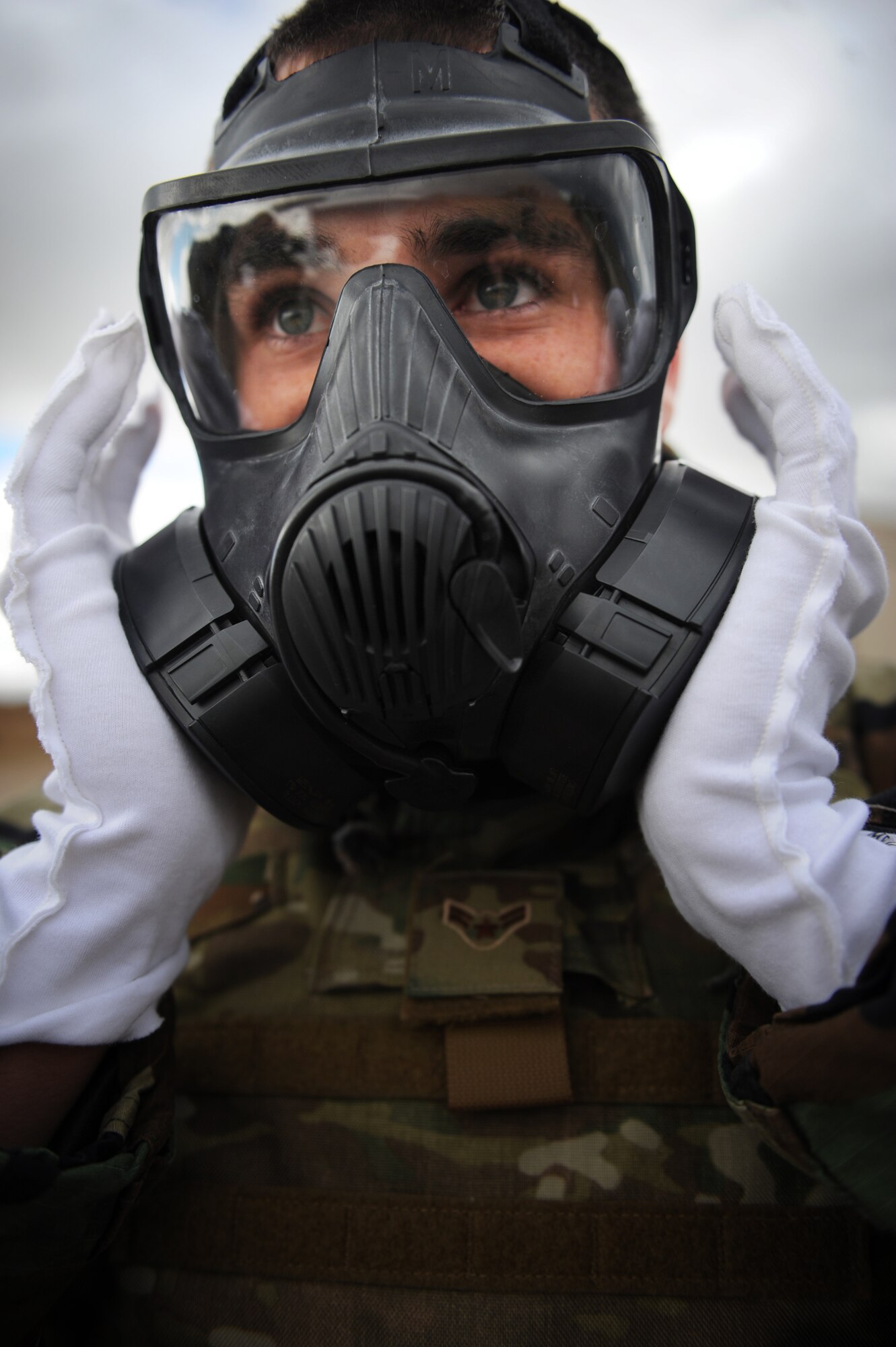 Airman 1st Class Cole Edwards, an Explosive Ordnance Technician with the 775th EOD Flight, checks the seal on his gas mask before entering a scene believed to contain chemical weapons. Edwards, and other Airmen from the flight, participated in a week-long training event Nov. 2.-6, meant to pass on knowledge from veteran EOD techs to their younger counterparts. (U.S. Air Force photo/Micah Garbarino)