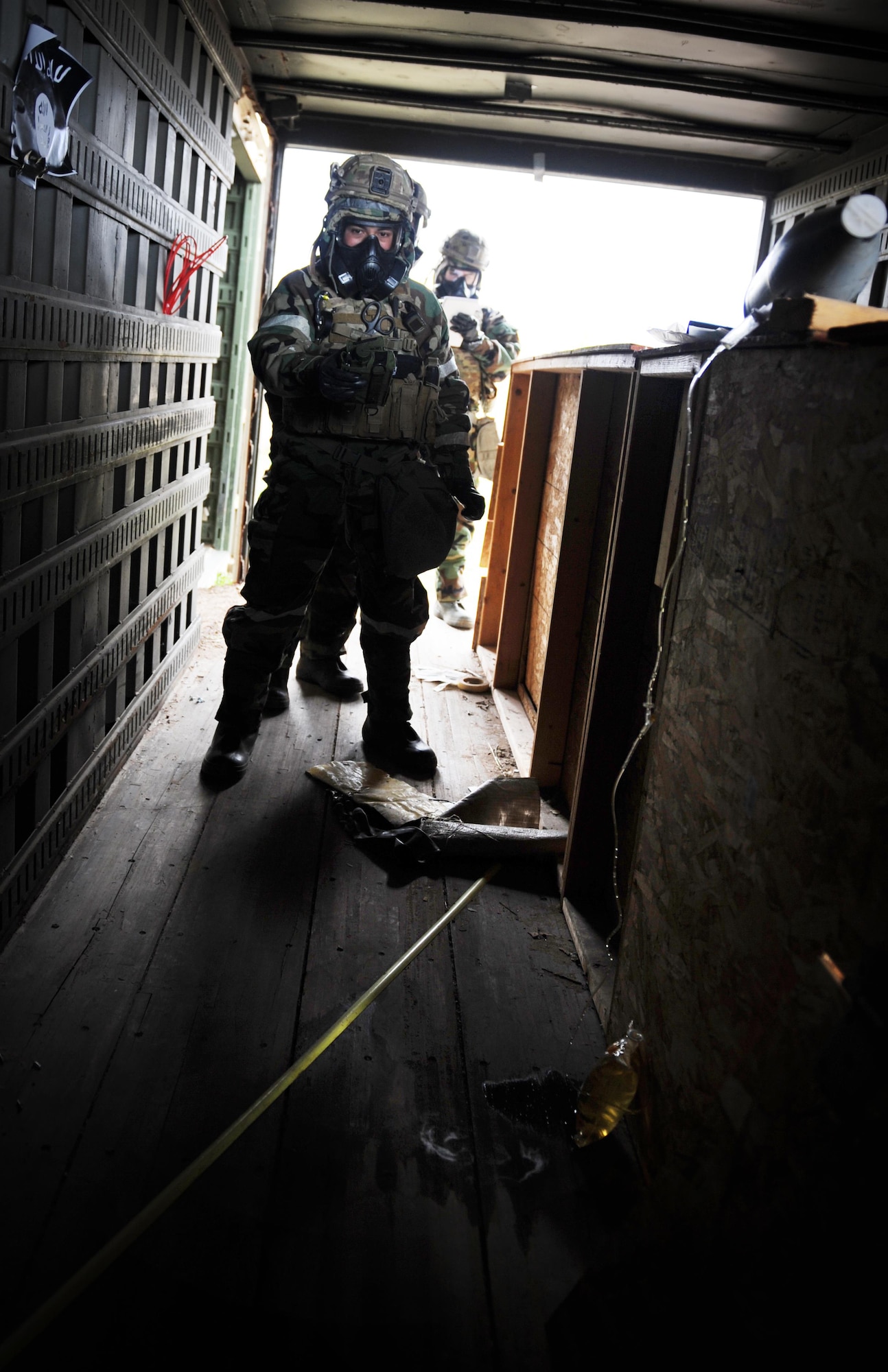 The 775th Explosive Ordnance Disposal Flight recently conducted a weeklong training event at Hill Air Force Base, Utah. In one training scenario, law enforcement officers have raided the lab of a bomb maker, evacuated to a safe distance, and called on the 775th EOD Flight to investigate the scene. Senior Airman Edgar Vasquez uses a chemical “sniffer” to determine which harmful, weaponized agents are present before the team can begin processing the scene. The bomb maker drained a chemical warhead for use with an IED. (U.S. Air Force photo/Micah Garbarino)