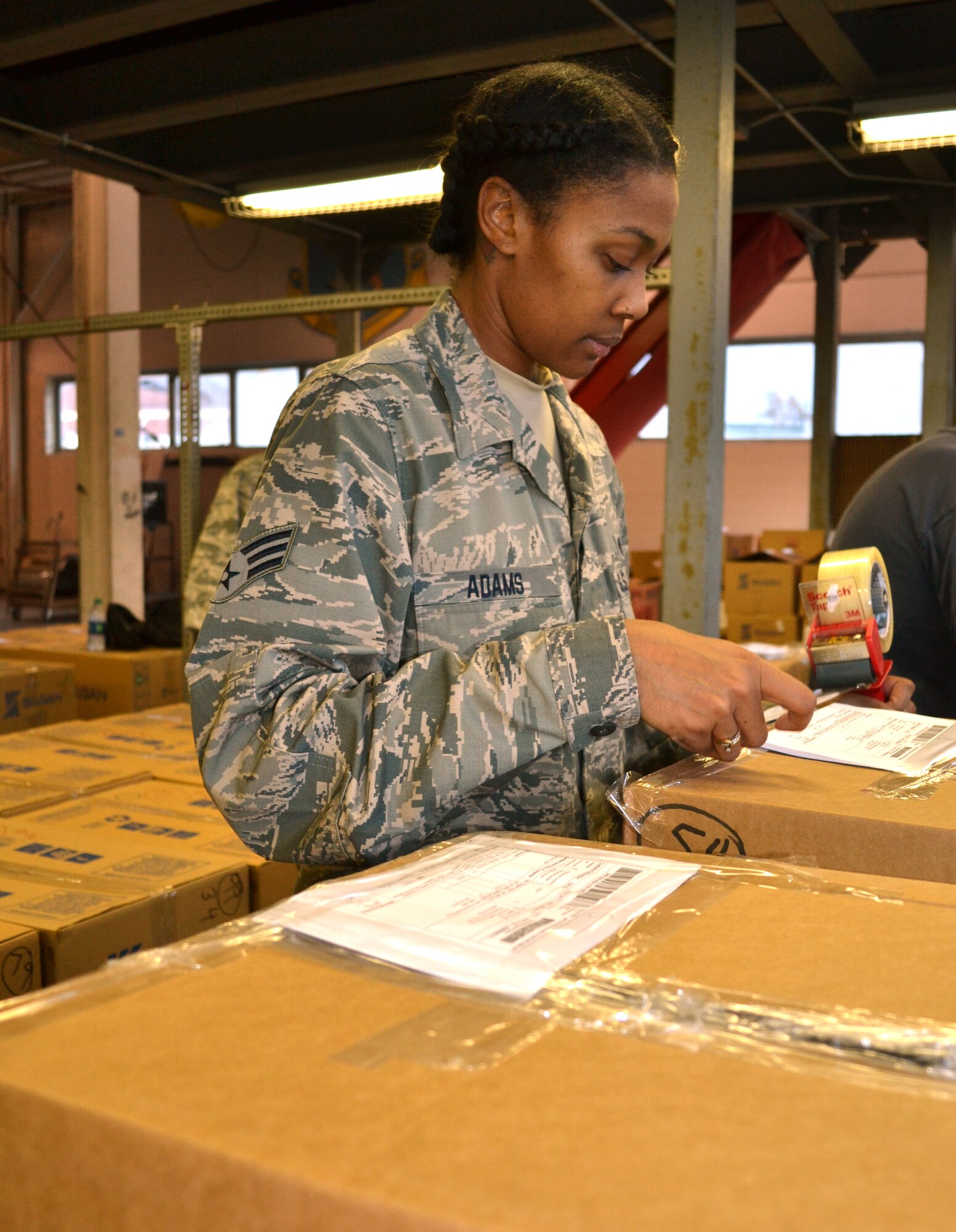 Senior Airman Charlissa Adams, 111th Services Squadron, helps tape care packages as they are being loaded to be sent out to deployed military members from Horsham Air Guard Station, Pennsylvania, Nov. 19. 2015. Approximately 5,000 packages are in the process of being shipped overseas. (U.S. Air National Guard photo by Tech. Sgt. Andria Allmond/Released)