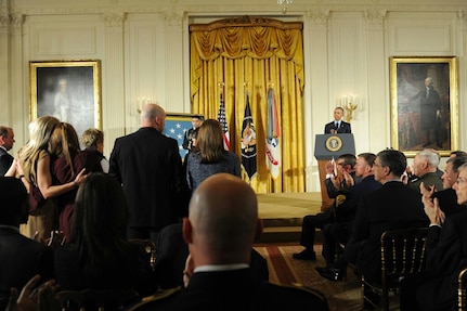Heather Gray (far left) stands up with other Gold Star wives, as they are recognized by President Barack Obama during a Medal of Honor presentation for retired Army Capt. Florent Groberg at the White House Nov. 12, 2015. Groberg was with Heather’s husband, Maj. David Gray, when he was killed in action Aug. 8, 2012, during a deployment to Afghanistan. (Courtesy photo)