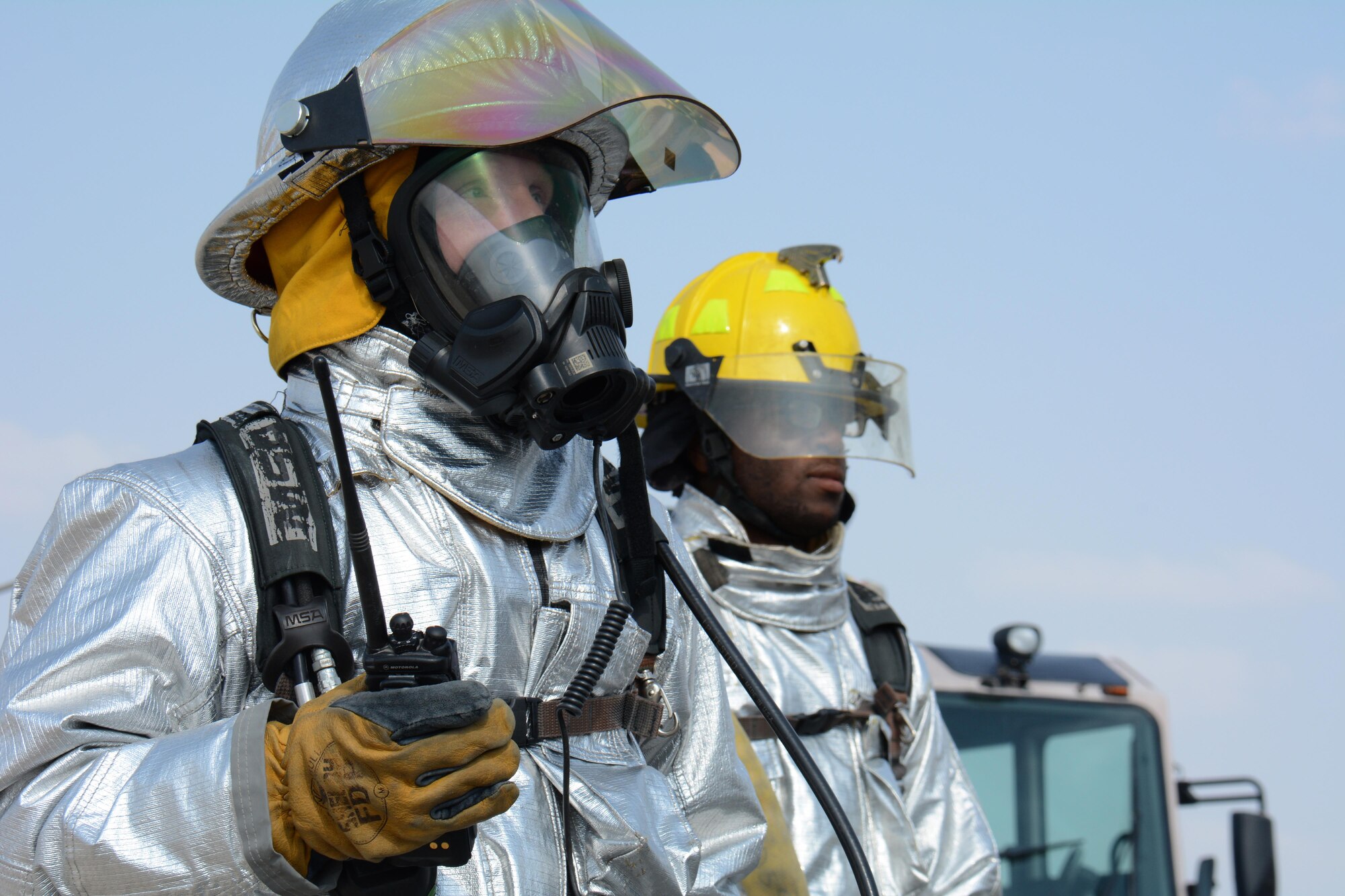 A 379th Civil Engineer Squadron firefighter listens to his radio during a training exercise at Al Udeid Air Base, Qatar Nov. 20. The exercise featured a simulated fire on a KC-135 Stratotanker and required firefighters to rescue an injured air crew member. Within minutes, several firefighters climbed on to the plane's left wing, entered the aircraft and pulled the injured air crew member to safety. Training exercises help first responders maintain their skillsets. (U.S. Air Force photo by Tech. Sgt. James Hodgman/Released)