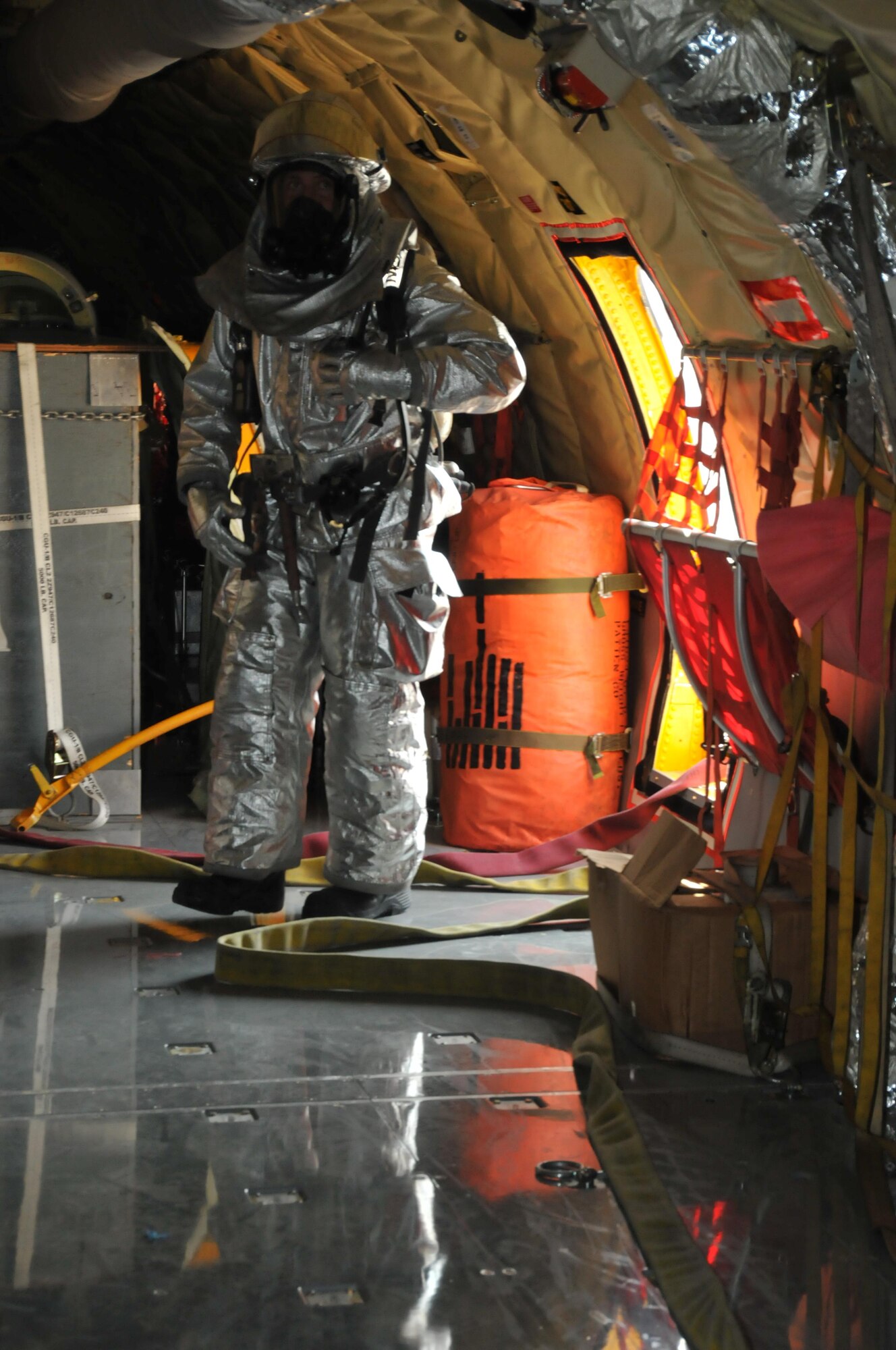 Firefighters from the 379th Expeditionary Civil Engineer Squadron arrive on the scene of a mock KC-135 Stratotanker fire Nov. 20 at Al Udeid Air Base, Qatar. Firefighters opened the access door of the plane to put out the fire and rescue an injured air crew member. (U.S. Air Force photo by Tech. Sgt. Terrica Y. Jones/Released)