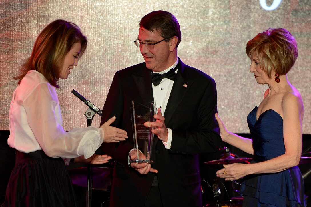 Secretary of Defense Ash Carter receives the Lifetime of Service award from the American Red Cross in the National Capital Region during the organization's annual Salute to Service Gala at the Hilton Hotel in McLean, VA., Nov. 20, 2015. Carter has spent more than three decades leveraging his knowledge of science and technology, global strategy and policy as well as his deep dedication to the men and women of the Department of Defense to make our nation and the world a safer place. U.S. Army Photo by Sgt. Jose A. Torres Jr.