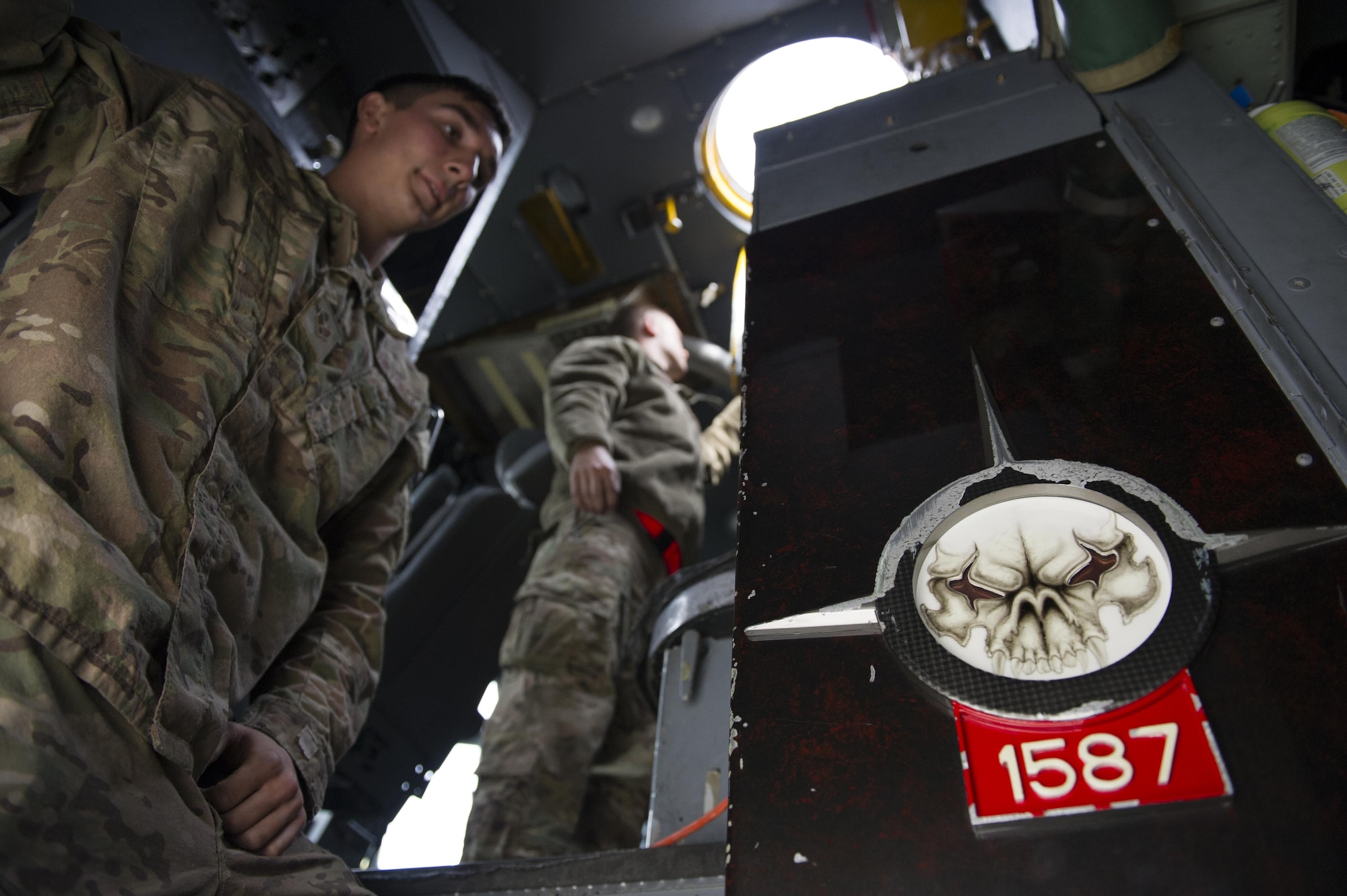 Senior Airman Dylan Shirey, 41st Expeditionary Aircraft Maintenance Unit aerospace repair crew chief, deployed from Davis-Monthan Air Force Base, Ariz., stands inside an EC-130H Compass Call before performing preventive maintenance inspections Nov. 19, 2015, at Bagram Airfield, Afghanistan. The Compass Call is an airborne tactical weapon system using a heavily modified version of the C-130 Hercules airframe. (U.S. Air Force photo by Tech. Sgt. Robert Cloys/Released)