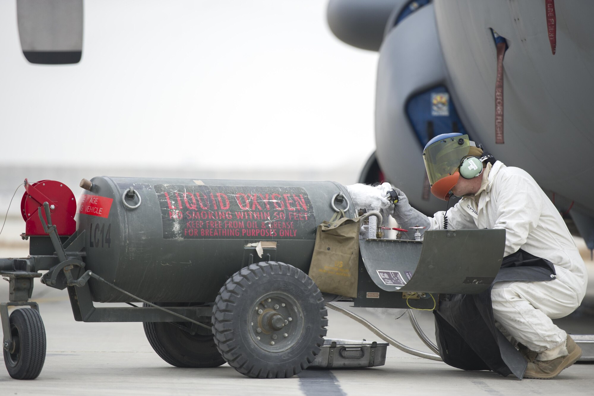 Senior Airman Clark Hoover-Hill, 455th Expeditionary Aircraft Maintenance Squadron electrical and environmental systems journeyman, deployed from Davis-Monthan Air Force Base, Ariz., checks a gauge on a tank of liquid oxygen before servicing an EC-130 aircraft at Bagram Airfield, Afghanistan, Nov. 19, 2015. The 455th EAMXS is responsible for preparing military aircraft on Bagram for flight and returning them to a mission-ready state once they land. (U.S. Air Force photo by Tech. Sgt. Robert Cloys/RELEASED)