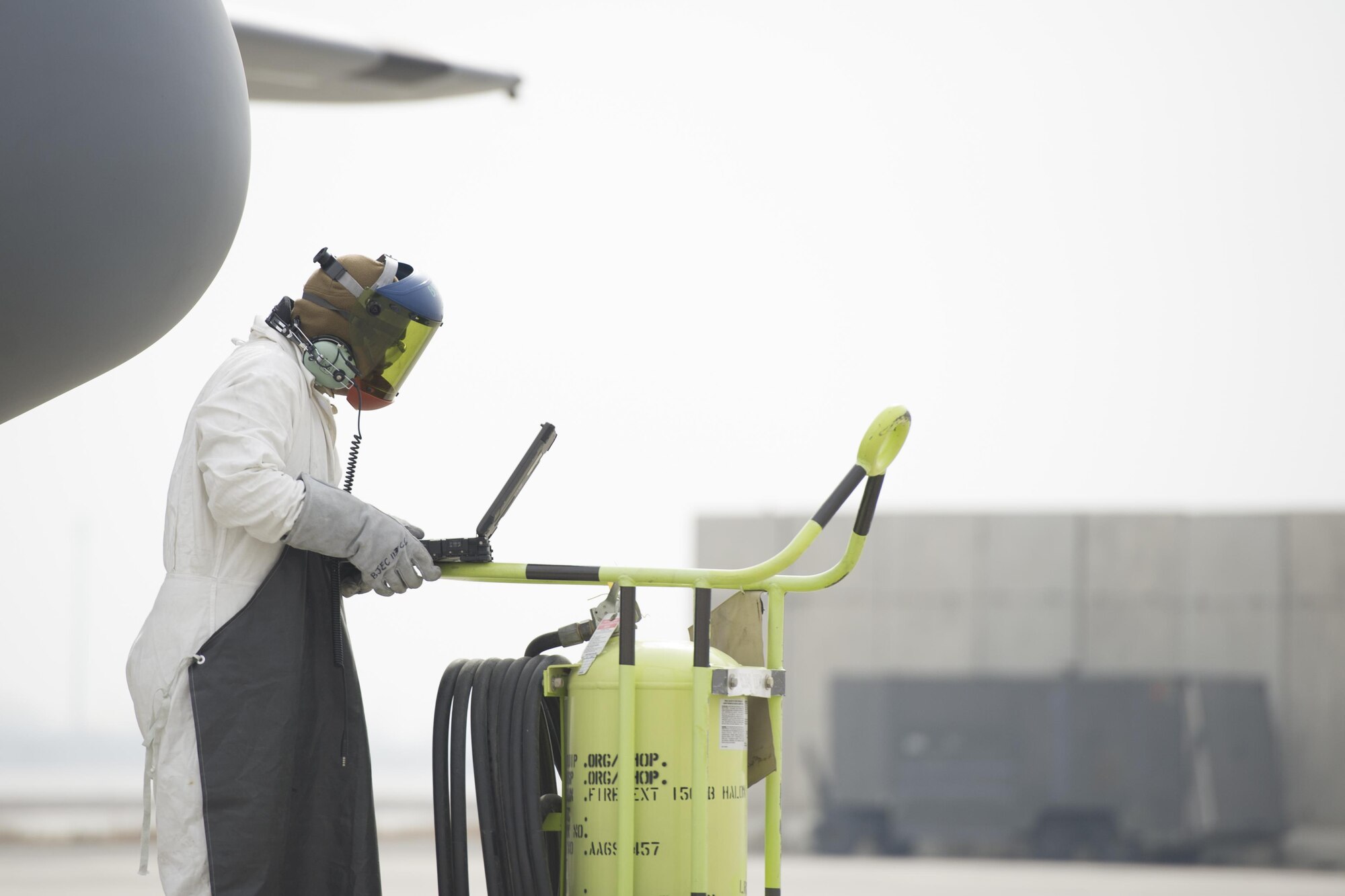Senior Airman Clark Hoover-Hill, 455th Expeditionary Aircraft Maintenance Squadron electrical and environmental systems journeyman, deployed from Davis-Monthan Air Force Base, Ariz., reviews a technical order before servicing an EC-130 aircraft with liquid oxygen at Bagram Airfield, Afghanistan, Nov. 19, 2015. The 455th EAMXS is responsible for preparing military aircraft on Bagram for flight and returning them to a mission-ready state once they land. (U.S. Air Force photo by Tech. Sgt. Robert Cloys/RELEASED)