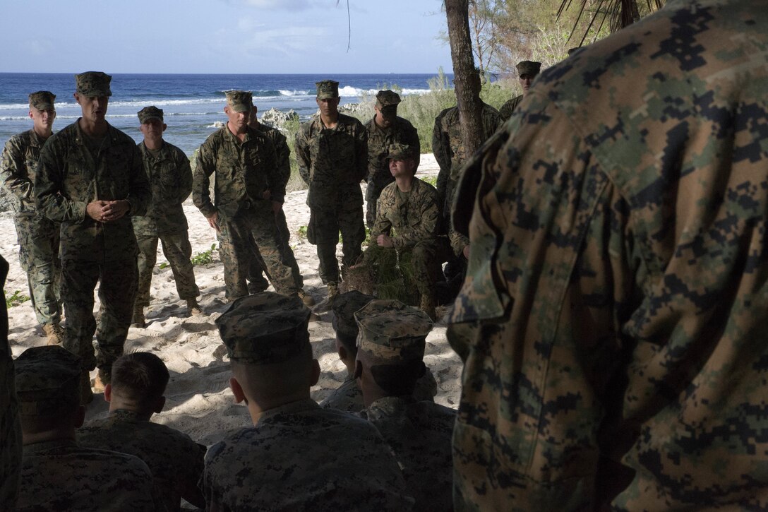 CHULU BEACH, TINIAN (November 17, 2015) -  Major Chris Merrill, Marine Corps Activity Guam Planning Representative, conducts professional military education on the realignment of Marines to the Pacific region with Marines of 1st Battalion, 2d Marine Regiment, Tinian, Commonwealth of the Northern Mariana Islands, on Nov. 17th, 2015.  The Marines have been deployed on short notice from Fuji to notionally secure the expeditionary airfield and conduct training.  The training allowed the Marines an opportunity to establish long range communications and receive professional military education in order to ensure utilization and validation of the Marianas Islands Range Complex, improve the Marines' understanding and appreciation for unit history, and validate elements of the Alert Contingency MAGTF.