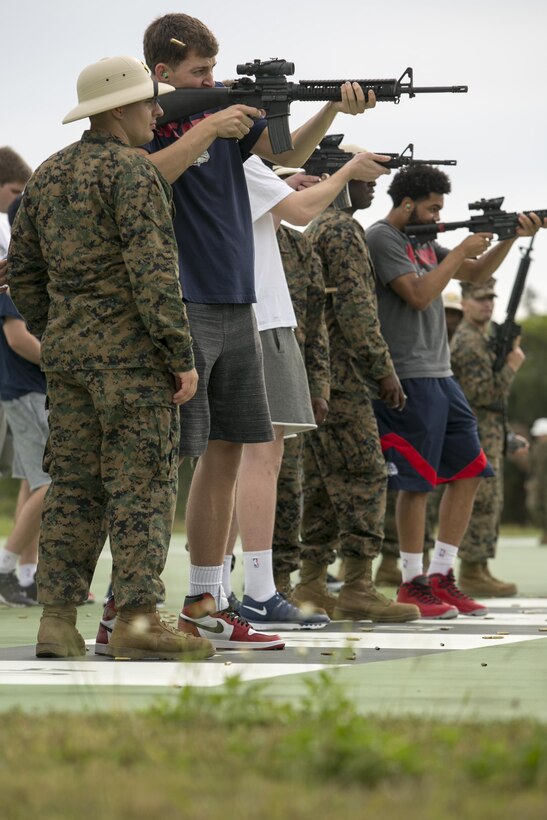 Gonzaga University guard Kyle Wiltjer fires a M16A4 service rifle during a visit to the range Nov. 13 aboard Camp Hansen, Okinawa, Japan. Gonzaga faced off against the University Pittsburg in the ESPN Armed Forces Classic Basketball Game held on Okinawa. This marked the fourth year the Armed Forces Classic was held and the second time it was played in East Asia.