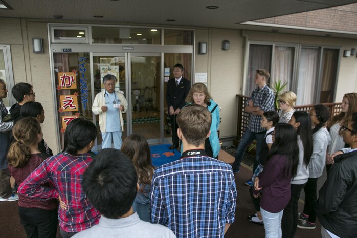 Fujimoto Toshifumi, owner of the Kaede Nursing Home in Iwakuni, Yamaguchi, Japan, greeted the National Honor Society students at the front door during their visit to the home, Nov. 17, 2015. Nineteen students visited the Kaede Nursing Home as a way to give back to the local community, experience a new culture and make new friends. Community relation events like this serve as an opportunity to strengthen the friendship between the station residents and the surrounding community.