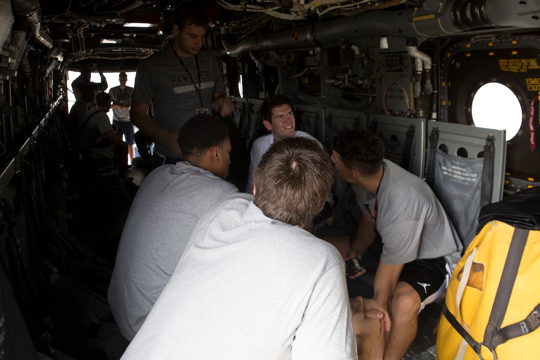 Players from the University of Pittsburgh Men’s Basketball Team sit inside an MV-22 Osprey Nov. 12 on Marine Corps Air Station Futenma, Okinawa, Japan. The team explored the inside of the Osprey and an AH-1 Super Cobra accompanied by Marine pilots during a tour of the flight line. Pittsburgh faced off against Gonzaga University in the ESPN Armed Forces Classic Basketball Game held on Okinawa. This marked the fourth year the Armed Forces Classic was held and the second time it was played in East Asia.
