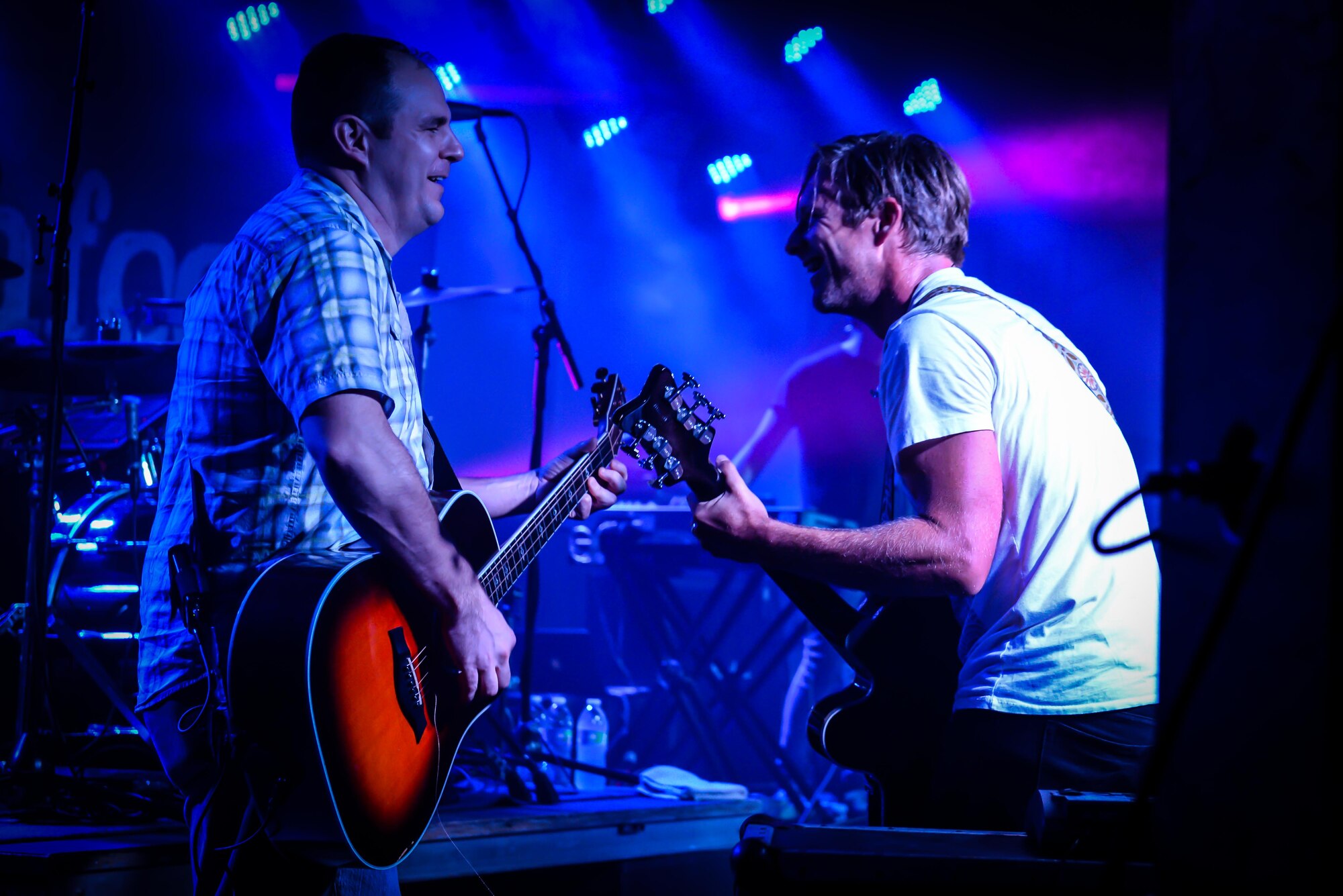 Switchfoot frontman Jon Foreman, right, plays a song chorus with Lt. Col. Jonathan Tucker, 734th Air Mobility Squadron commander, Nov. 21, 2015, at Andersen Air Force Base, Guam. The Grammy Award-winning band visited the island to perform tribute concerts for service members and families. (U.S. Air Force photo by Staff Sgt. Alexander W. Riedel/Released)