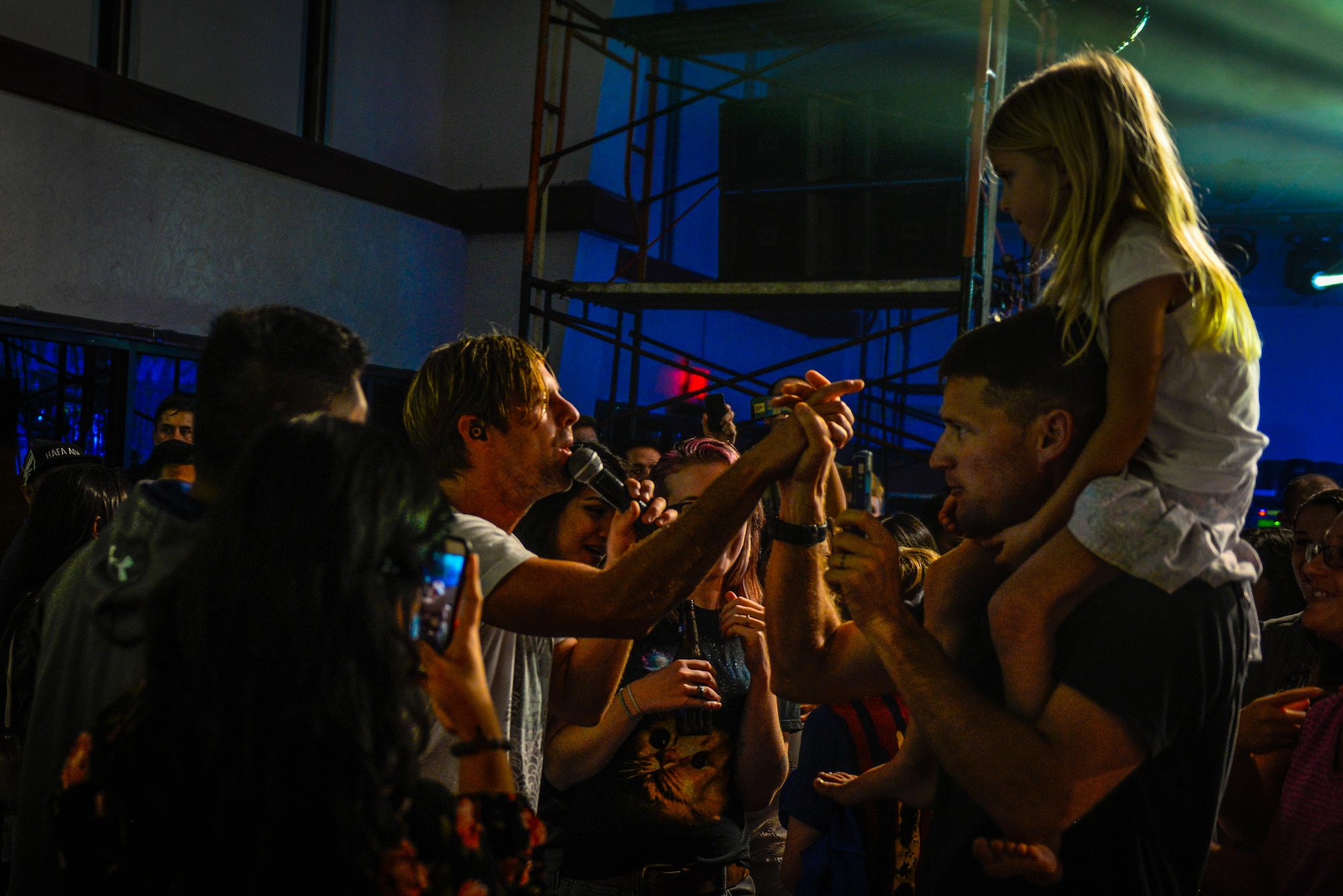 Switchfoot frontman Jon Foreman high-fives audience members during a song Nov. 21, 2015, at Andersen Air Force Base, Guam. The Grammy Award-winning band visited the island to perform tribute concerts to service members and families. (U.S. Air Force photo by Staff Sgt. Alexander W. Riedel/Released)