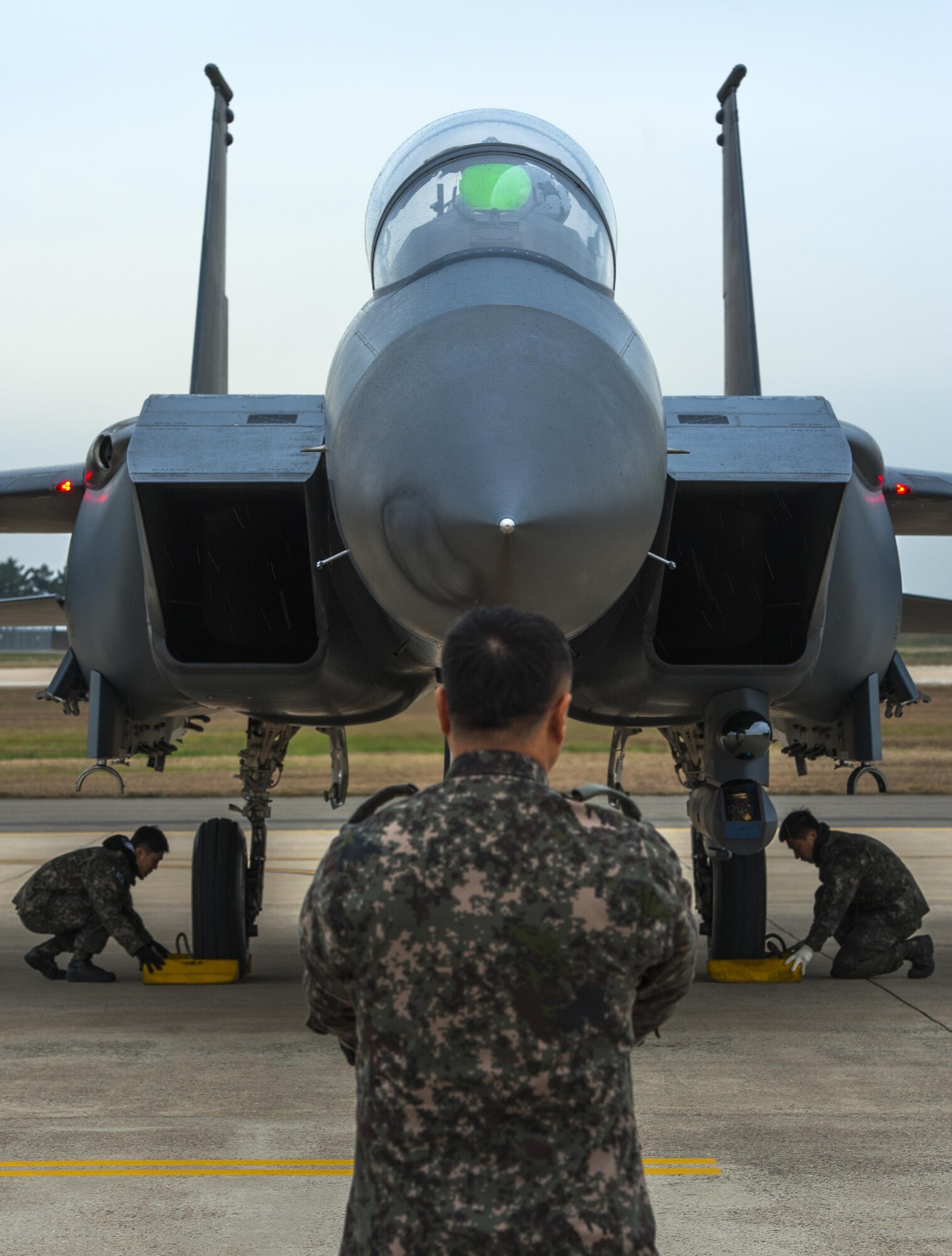 Maintainers from the from the 11th Fighter Wing, Daegu Air Base, Republic of Korea, place chalks in front of the landing gear of an F-15K Slam Eagle during Buddy Wing 15-7 at Kunsan Air Base, ROK, Nov. 16, 2015. Wolf Pack Airmen trained alongside Airmen of the 11th Fighter Wing, learning how to operate as one force with dissimilar fighter aircraft. (U.S. Air Force photo by Staff Sgt. Nick Wilson/Released) 