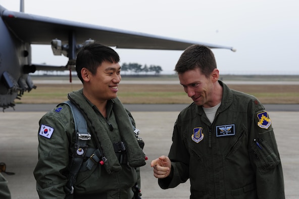 A pilot from the 11th Fighter Wing, Daegu Air Base, Republic of Korea, exchanges greetings with Maj. Matthew Belle, 35th Fighter Squadron director of operations, during Buddy Wing 15-7 at Kunsan Air Base, ROK, Nov. 16, 2015. During the five-day exercise, pilots from the 8th Fighter Wing exchanged tactics and procedures with their ROKAF counterparts. (U.S. Air Force photo by Staff Sgt. Nick Wilson/Released)                                                                                                                                                                                                                                                                             